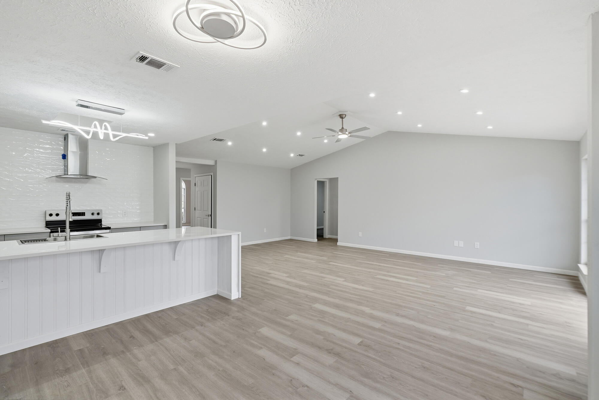 Welcome to this beautifully fully renovated 3-bedroom, 2-bath home in the heart of Lynn Haven, Florida. Thoughtfully updated with modern finishes and quality upgrades throughout, this move-in ready home offers both comfort and style.
Step inside to find durable and stylish luxury vinyl plank (LVP) flooring flowing seamlessly through the living spaces, complemented by recessed lighting that creates a bright, inviting atmosphere. The updated bathrooms provide a spa-like experience with heated floors-perfect for added comfort year-round.  The kitchen is a show stopper with a waterfall quartz island.