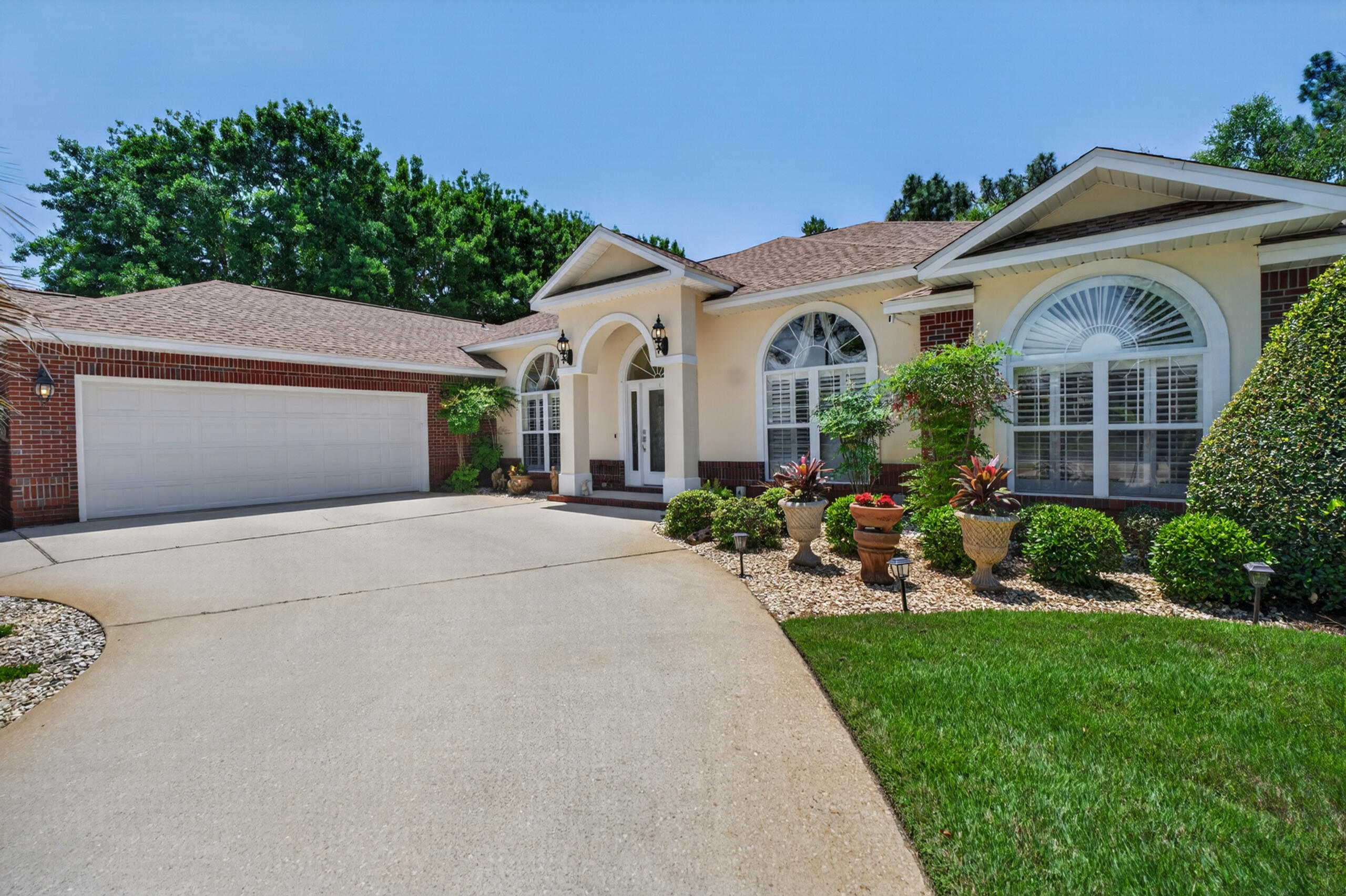 Tasteful, stylish, and thoughtfully designed, this custom-built 4-bedroom, 3-bath residence was created for those who appreciate spacious living and effortless entertaining. From the moment you step through the beautiful etched glass entry, the quality craftsmanship and extensive upgrades are immediately apparent. Smooth 9-, 10-, and 11-foot ceilings, rounded wall corners, elegant custom window treatments, and carefully selected finishes create an inviting sense of sophistication throughout. At the heart of the home is an exceptionally large eat-in kitchen and dining area designed to bring people together. Whether hosting holiday gatherings, dinner parties, or casual family evenings, this impressive space flows seamlessly into the centrally located family room and beyond to the outdoor living area. A dramatic 9-foot sliding pocket door opens completely to the covered lanai and heated pool, creating an expansive indoor-outdoor experience ideal for Florida living. The thoughtfully designed split floor plan offers privacy and comfort, with the owner's retreat tucked away at the rear of the home. The spacious primary suite features elegant tray ceilings and French doors leading into a truly luxurious spa-inspired bath. Indulge in the oversized Roman shower, relaxing soaking tub, dual vanities, private water closet, and expansive walk-in closets complete with built-in shelving and dressers designed to maximize space and organization.Guest bedrooms are generously sized with abundant storage, including one featuring an impressive walk-in closet with an additional private storage room. The third bath conveniently serves both the family room and pool area, making outdoor entertaining even more effortless. And for those who appreciate exceptional garage space, this oversized 717-square-foot garage delivers room for vehicles, storage, hobbies, and a dedicated workspace. Situated on a beautifully landscaped corner lot with extra elbow room and curb appeal, this home combines luxury, function, and everyday comfort. Additional features include hurricane panel hardware for added peace of mind. Built to live large and designed to enjoy--this is a home that truly lives as beautifully as it looks.