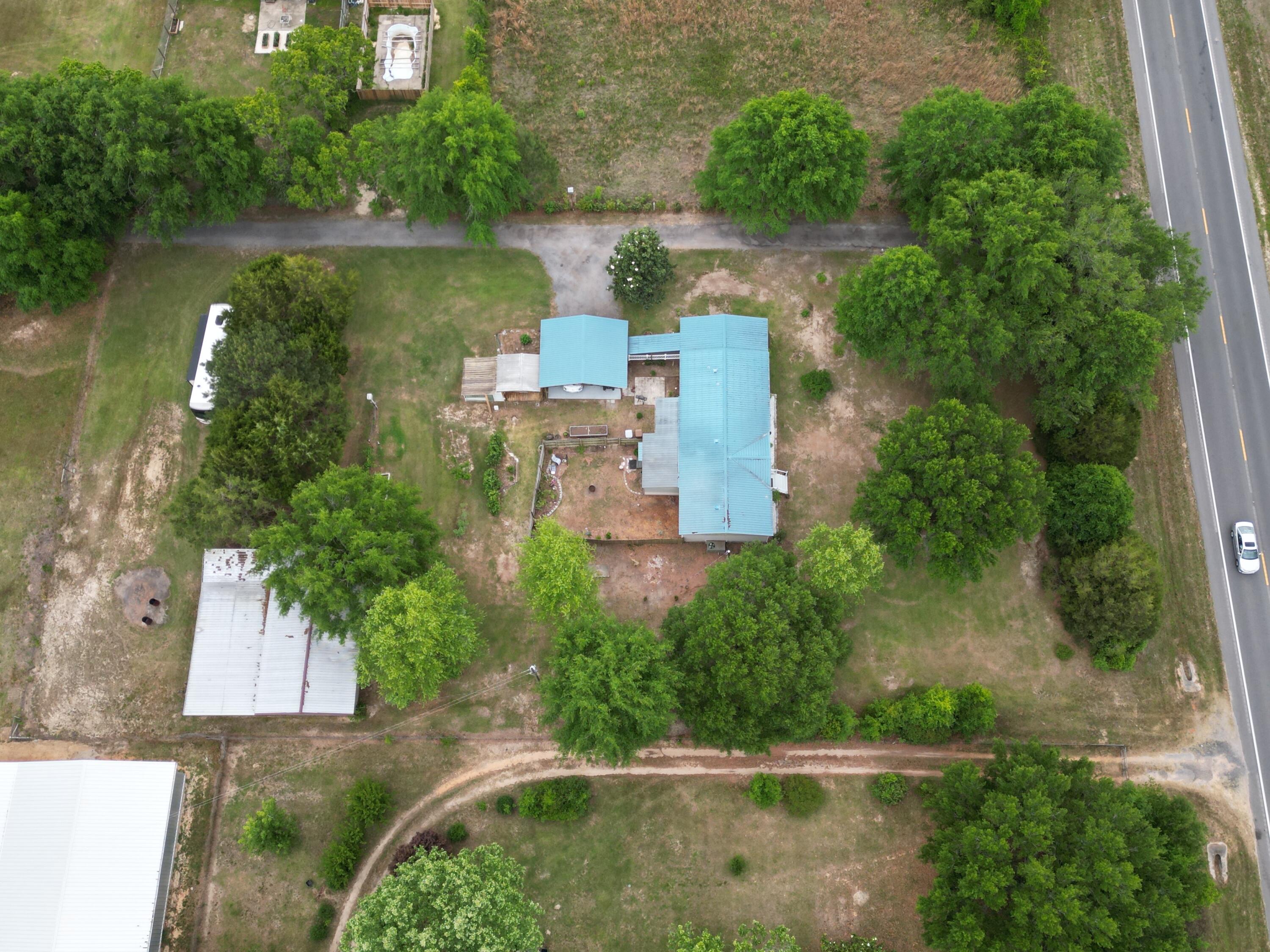 ***UNDER CONTRACT but will continue to show and take backup offers.***Set on 1.34 private acres, this thoughtfully equipped property is designed for those who value space, function, and the outdoors--offering a fully equipped country lifestyle with room to live, work, and pursue your passions.

This move-in ready 3-bedroom, 2-bath home features an open floor plan and a fully renovated kitchen with abundant counter space, soft-close cabinetry, granite island, updated appliances, and modern finishes--perfect for both everyday living and entertaining. Ceiling fans throughout the home and on the porch add comfort year-round, while a handicap-accessible ramp with durable Trex-style decking provides added convenience and ease of entry. The spacious primary suite includes vaulted ceilings, a large walk-in closet, and an en suite bath with soaking tub, separate shower, and linen storage.

Enjoy the expansive sunroom overlooking a fenced backyard retreat--ideal for relaxing, pets, or gardening. A separate outdoor patio area offers additional space for entertaining and enjoying the peaceful surroundings.

The property is thoughtfully equipped for those who enjoy hobby farming, entertaining, or working from home. A standout feature is the impressive 1,692 SF barn (2015), including 864 SF of air-conditioned workspace with running water, 220 amp service, loft storage, and four covered exterior bays with power and lighting--ideal for equipment, projects, or additional parking.

Additional highlights include:

Two RV hookups with septic access
Greenhouse, she shed, raised garden beds, and worm beds
Established fruit trees and plants including grapes, blackberries, blueberries, peach, tangerine, guava, and more
Water and electric access throughout the property
Fish cleaning station with integrated worm bed
Outdoor prep areas including a hunter's game lift
Durable metal roof (approx. 5 years old) and 2024 water heater
Security system
Shared main driveway access, plus a separate private driveway with ample parking and covered carport

With a rare combination of privacy, functionality, and outdoor lifestyle amenities, this property offers something for everyone--from peaceful country living to space for hobbies, work, and recreation.

Schedule your private showing today to experience all this unique property has to offer.