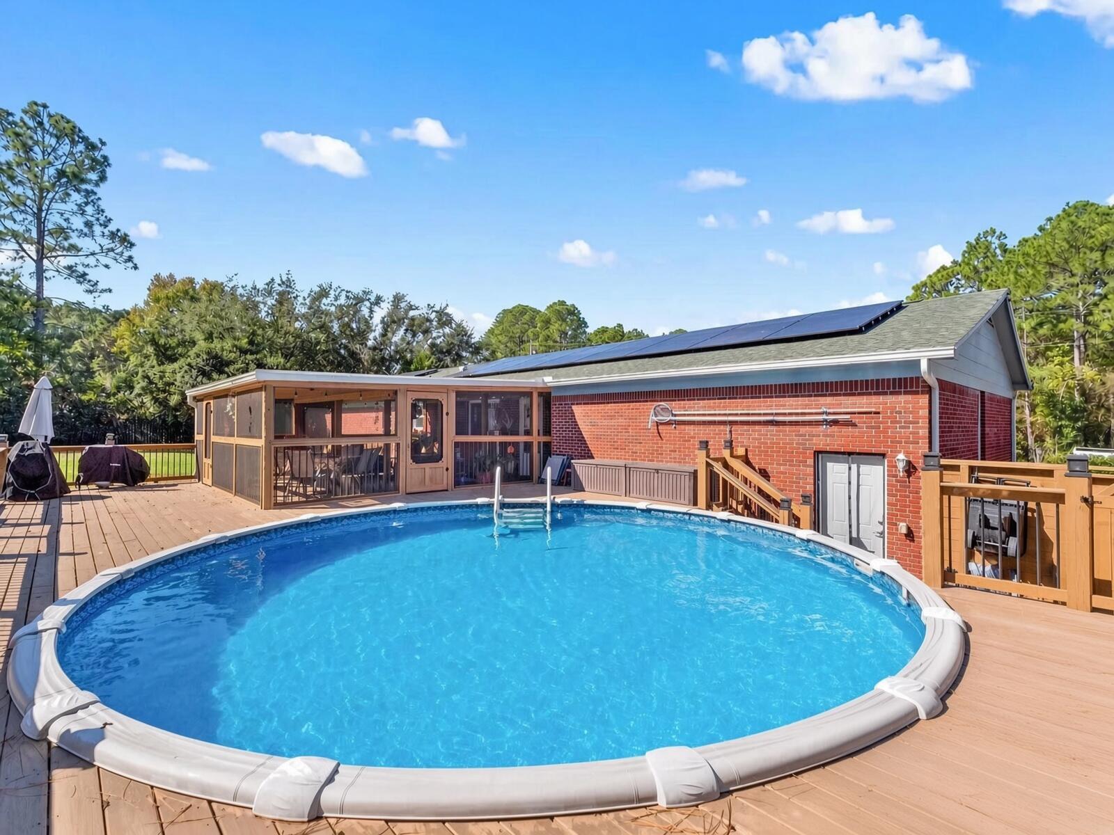 If you need a home that has plenty of room to spread out, this is one you will want to see. Located on just over an acre in East Navarre, this 3-bedroom, 2-bath home offers 1,827 square feet, a two-car garage and plenty of space to park an RV or boat or several!
Inside, the home features an updated kitchen with granite countertops, a deep sink and newer appliances. Luxury vinyl plank flooring runs throughout the home, and the vaulted ceiling and fireplace give the main living area an open and comfortable feel. The large backyard has plenty of room to enjoy and includes an above-ground pool, storage shed, covered deck and screened porch. Hurricane-impact windows, a whole-house water-filtration system, seamless gutters and paid-off solar panels add even more value.  Located on a quiet street with no HOA, this property gives you the space and privacy that can be difficult to find in Navarre while still being convenient to the beaches, military bases, schools and shopping.  Make your appointment today