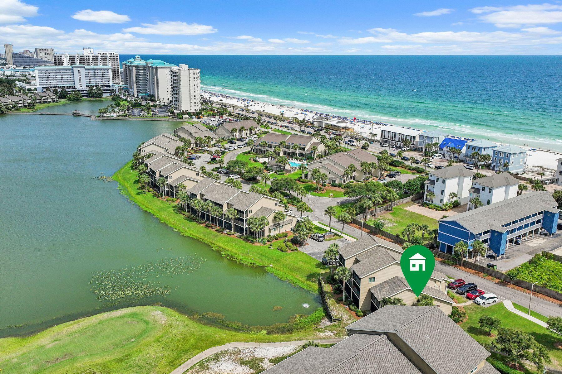 IMPRESSIVE RENTAL HISTORY & $65K+ in GROSS RENTAL INCOME ALREADY FOR 2026 & STILL BOOKING! Nestled within the sought-after Lakefront Villas enclave of Seascape Resort, this beautifully updated end-unit townhouse offers a front-row seat to some of the community's most picturesque views. Overlooking Stewart Lake and the 14th fairway, the residence combines the tranquility of a waterfront setting with the convenience of resort living just moments from the beach. Additional side windows unique to its corner location fill the home with natural light, while the absence of neighbors above or below creates the privacy and feel of a single-family residence.

Inside, thoughtful renovations elevate every space. The open-concept living area features high ceilings, recessed lighting, tile and luxury vinyl plank flooring, and seamless flow between the kitchen, dining and living spaces. The renovated kitchen is designed for both entertaining and everyday enjoyment, offering quartz countertops, stainless steel appliances, a wine refrigerator and abundant storage. Updated bathrooms showcase quartz-topped vanities and beautifully tiled walk-in showers, continuing the home's polished coastal aesthetic.

The flexible three-bedroom floor plan accommodates owners and guests with ease. A first-floor guest bedroom has direct access to a shared bath, while upstairs, the lakefront primary suite serves as a private retreat with a sitting area and a screened balcony overlooking the water. A second upstairs guest bedroom provides additional privacy, and dual screened balconies create inviting outdoor spaces for morning coffee, afternoon breezes and sunset views across the lake and fairway.

Equally impressive is the extensive list of improvements already completed. A new roof, impact-rated windows and doors, and Hardie board siding were installed in 2022, followed by a new HVAC system in 2023 and a new water heater in 2026, allowing the next owner to focus on enjoying the property rather than updating it.

Life at Seascape Resort extends far beyond the front door. With 300 acres of lush greens and tranquil lakes, easy and convenient access to more than 2,000 feet of deeded sugar-white beach frontage, and five community pools, including a heated pool nearby, you are sure to have year-round enjoyment. Residents and guests also enjoy tennis and pickleball courts, golf, basketball courts, playgrounds, picnic areas, on-site dining and entertainment, golf cart & bike rentals, as well as the nearby shops and restaurants at Seascape Towne Center and along pedestrian friendly Scenic Highway 98. Whether envisioned as a primary residence, vacation retreat, or investment opportunity, this turnkey property delivers an exceptional coastal lifestyle in the heart of Miramar Beach.