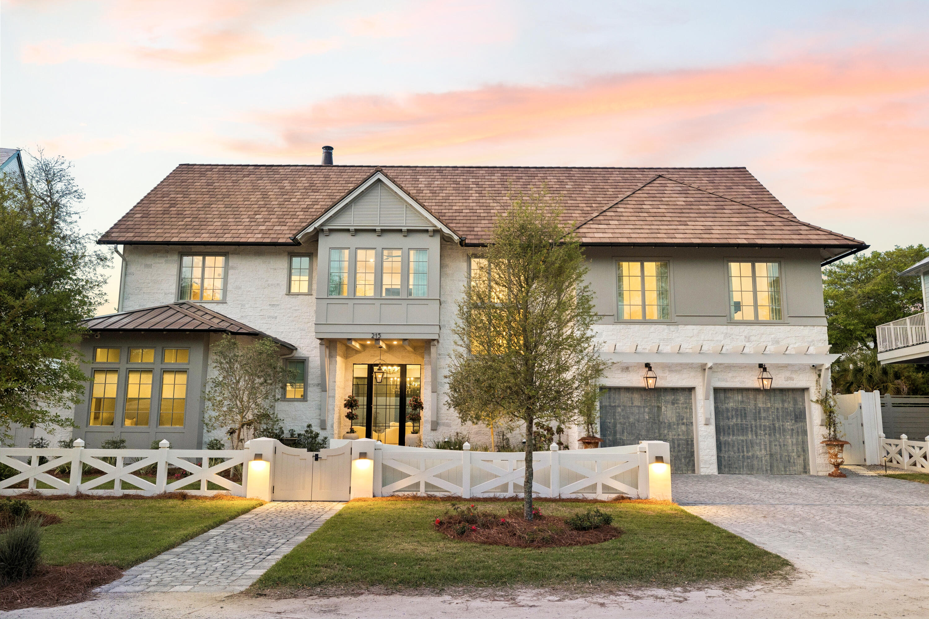 Quietly set behind custom fencing and curated landscaping, this home reveals itself through materials, proportion, and restraint rather than excess. Approached through a gated entry and landscaped courtyard, the residence establishes a sense of privacy and intention from the outset. A cobblestone drive, olive trees, and the sound of a fountain set a quieter tone, more retreat than residence.
Conceived not as a speculative project but as a home built to endure, Dogwood draws on European architectural tradition rather than the expected coastal vernacular. Every decision, from material selection to proportion, reflects a commitment to timeless design and craftsmanship that becomes more meaningful with age. The home sits within walking distance to the Gulf, with no HOA.
Inside, the materials do the work. Reclaimed French limestone underfoot, hand-finished plaster walls, and antique beams create a sense of permanence that is difficult to replicate. The main living spaces unfold gradually, not all at once, designed to feel discovered rather than exposed.
 The interior sequence continues with a measured progression through the home's primary living areas. Ceiling heights shift subtly, creating variation without disrupting continuity, while sightlines are maintained to preserve openness. Natural light is controlled rather than maximized: filtered, directional, and consistent throughout the day. Circulation is intuitive, allowing movement from one space to the next without interruption or excess.
The kitchen and adjacent living areas read as a single environment. Surfaces remain understated, emphasizing texture over contrast, while Sub-Zero and Wolf appliances are integrated without drawing attention. A fully equipped butler's pantry supports the space, keeping the primary kitchen functional and visually calm during entertaining.
The central living area opens fully to the outdoors through expansive glass doors, dissolving the boundary between interior and exterior. Openings are wide but deliberate, reinforcing connection without excess. What follows is a sequence of spaces built for use: covered seating, a summer kitchen, and a pool and spa environment that functions as a true extension of the home. It's designed for long afternoons and evenings that don't require leaving the property.
The primary suite is positioned for privacy and separation from the main living areas, functioning as a true retreat within the home. The bedroom itself is restrained in scale and detail, allowing proportion, light, and material to define the experience rather than decoration. The primary bath follows this same approach, quietly executed, consistent in material, and designed to support daily use without drawing attention.
A dedicated office is positioned with intention, quietly removed yet integrated into the overall flow. It functions as a true workspace, with appropriate scale, light, and privacy for extended use.
Private spaces are intentionally separated. Guest suites and bunk-style accommodations allow for scale when needed, while maintaining comfort and privacy. An upstairs living area with a full bar creates a secondary gathering space, ideal for guests or extended stays.
Throughout, the house balances refinement with practicality: multiple laundry areas, integrated storage, a light-filled bonus space suited to a gym, wellness retreat, or media room, and a glass-enclosed, temperature-controlled wine room that adds a further layer of quiet luxury.
The result is a home designed to be lived in for a lifetime, not simply passed through: durable, private, and intentionally built for the way a true forever home is experienced.