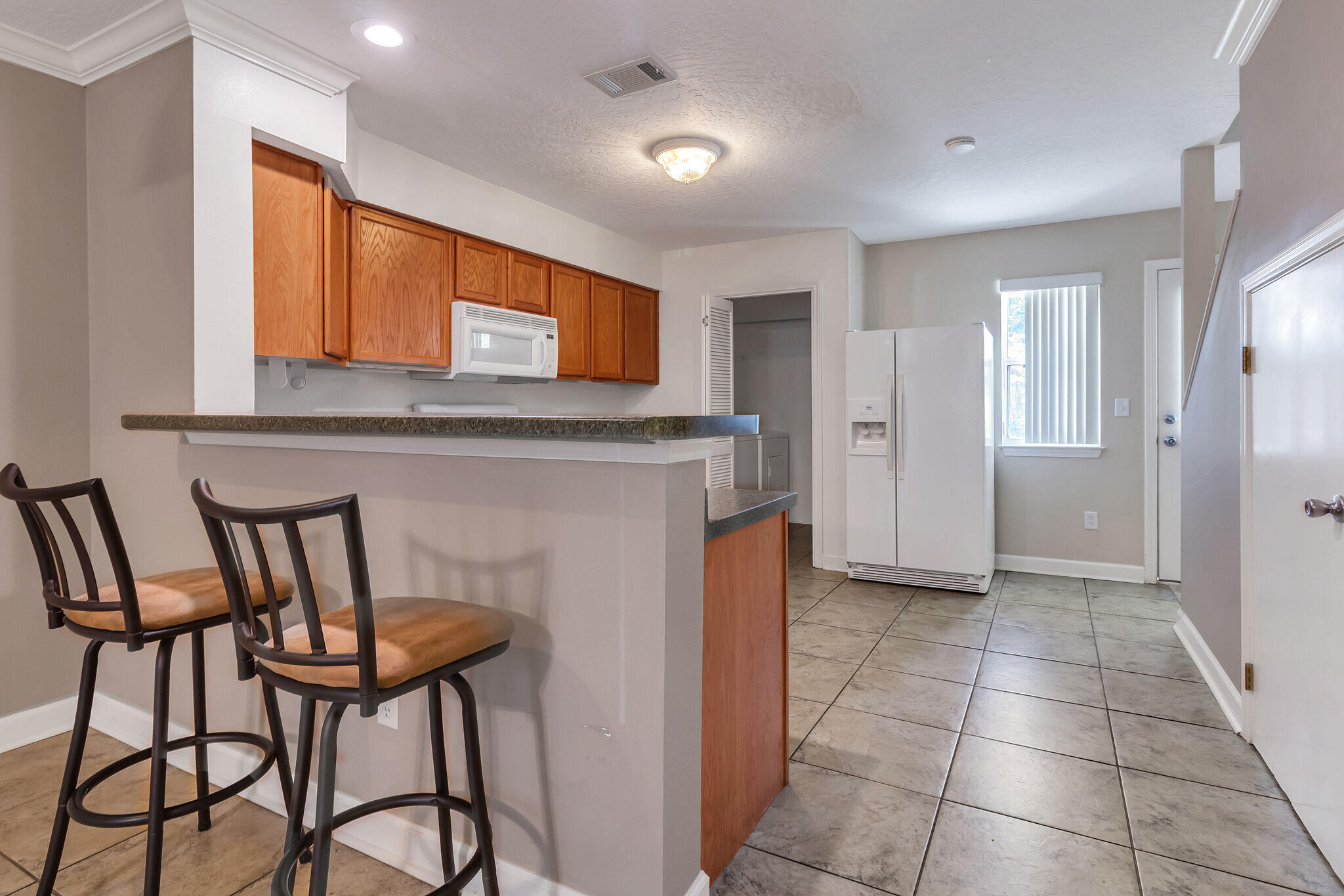 As you step inside you'll find tile floors flowing through the first floor living room, dining and kitchen. In addition there is a half bath and laundry on this main floor. Located on the second floor is 2 Bedrooms and 2 FULL Baths. The community offers a pool and club house. This END UNIT in Shay-Lin townhomes is an Amazing opportunity! Convenient to base or beach!