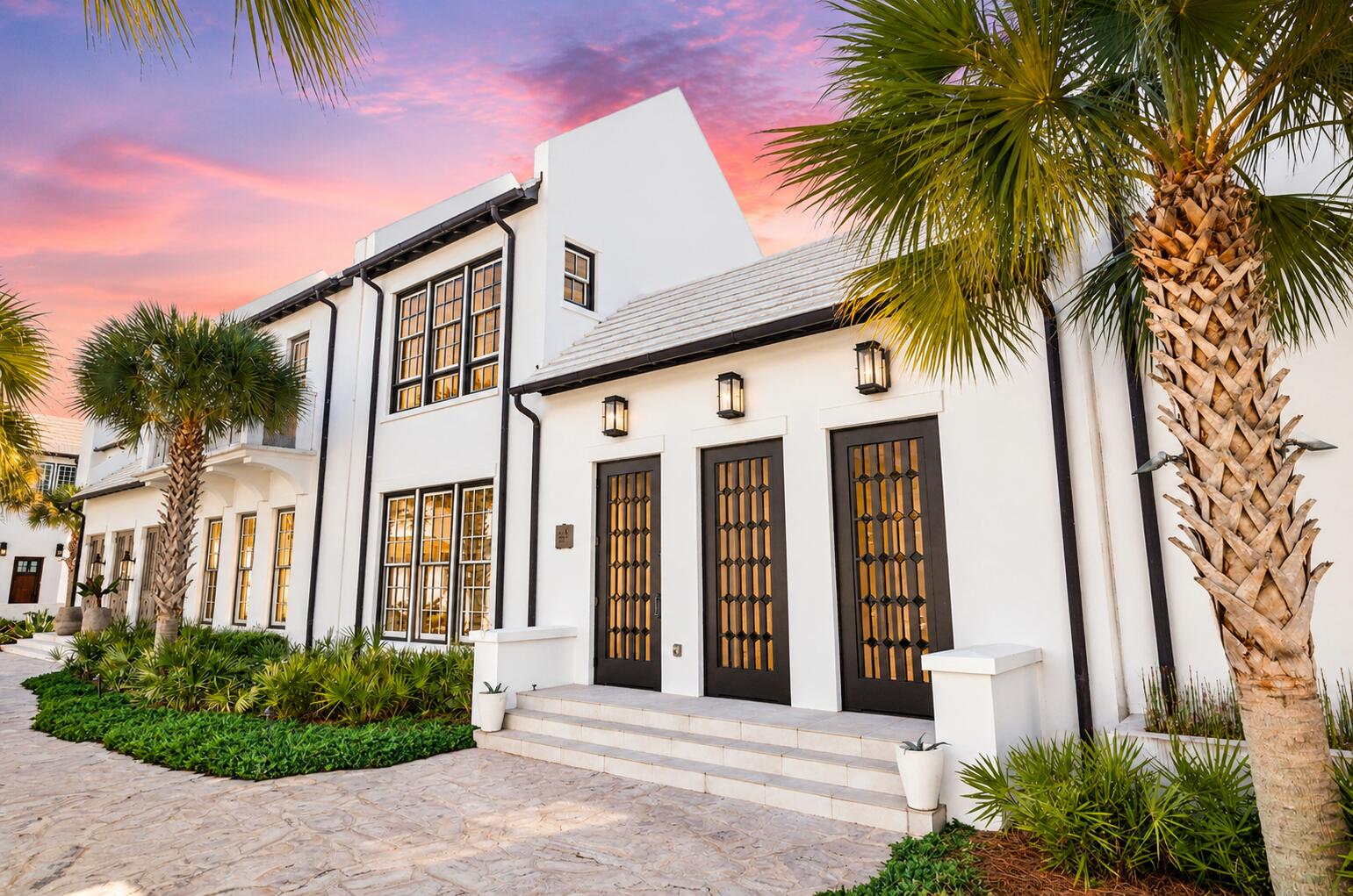 Alys Beach is a town built around the courtyard, and few streets hold that idea as quietly as Fonville Court, a short, private run of white masonry that rarely changes hands. It's here that 51 Fonville sits: close to town center and the Gulf, yet set within one of Alys Beach's stiller residential pockets, moments from Raw & Juicy and the neighborhood playground. Completed in 2020, the two-story residence unfolds across four bedrooms and three-and-a-half baths. White plaster walls, wide-plank hardwood, and exposed beams give the interiors a sense of calm and craft, with light moving through the rooms from morning to dusk.

At the center, the great room opens fully to the courtyard, a gas fireplace anchoring the space. The kitchen is understated and has exactly integrated premium appliances, clean lines, a design as suited to a slow morning as to an evening with a full table.

The primary suite rests on the first floor, held apart from the guest quarters above. Upstairs, two bedrooms share a bath, while a separate guest suite claims its own full bath and private terrace.

Beyond the glass, more than 1,000 square feet of private outdoor living wraps the courtyard pool, the true heart of the home. A covered loggia and dining area draw the interiors into the open air, offering the kind of seclusion that has become increasingly rare in this part of Alys Beach.

Impact-rated windows and doors, a tankless gas water heater, and covered parking for two complete the residence.

Deeded Gulf access lies roughly five minutes away via Turtle Bale Path, with Alys Beach's pools, fitness center, tennis and pickleball courts, sauna, dining, and town center all close at hand.

For the buyer who has waited for the right home in an established Alys Beach setting, 51 Fonville rewards a closer look.
