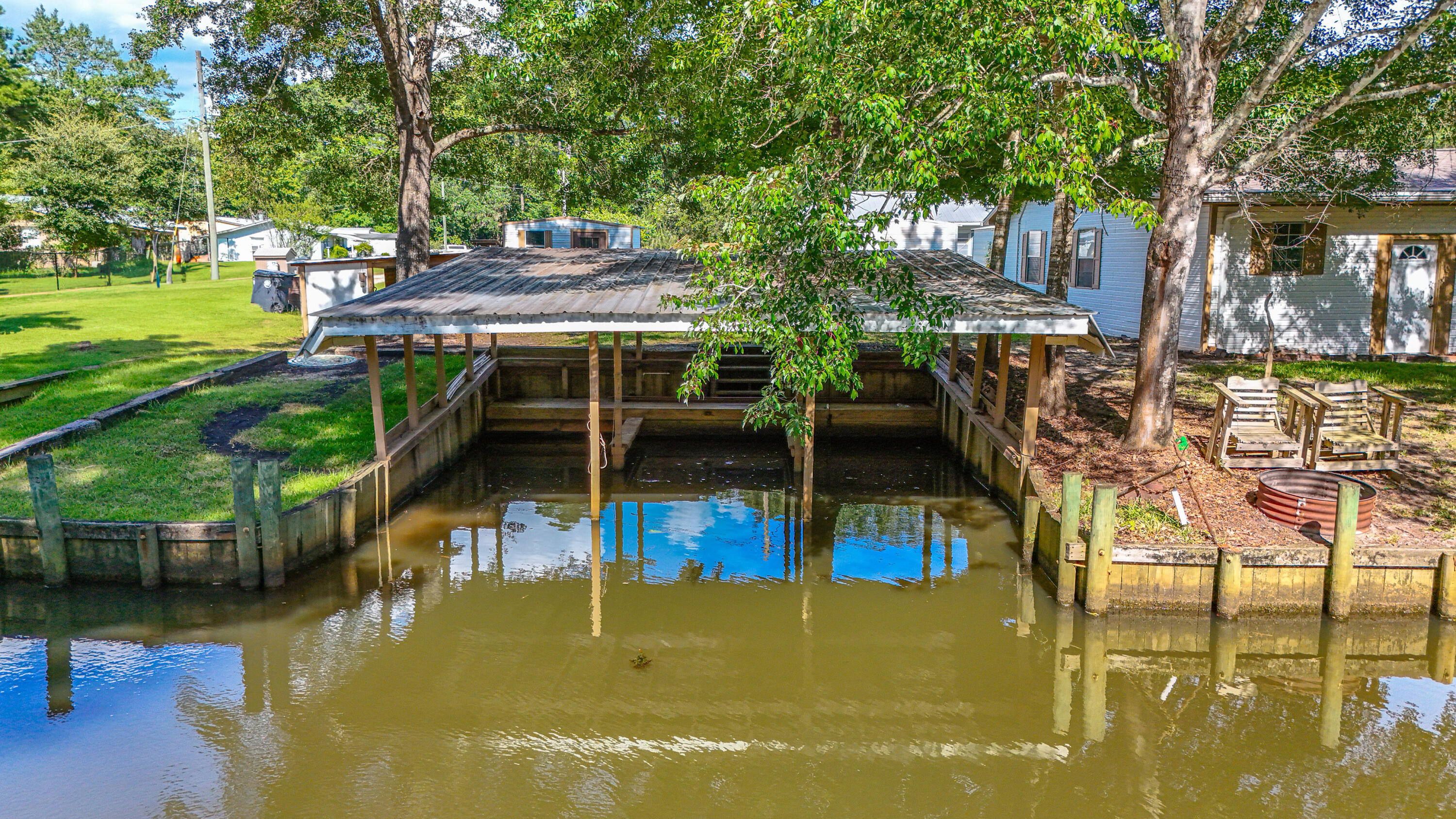 AMAZING OPPORTUNITY!!  Waterfront Living at Its Finest! Nestled in Bunker Creek, this Southern-style retreat sits on .21 acres with 125 feet of waterfront along a 20' wide, 4' deep canal. Enjoy boating and fishing with 3 covered boat slips, a sea wall, and quick access to Choctawhatchee Bay, the intracoastal, and Crab Island. Inside, the 2BR/2BA layout features a bright kitchen, cozy fireplace room, and screened porch perfect for sunsets. Whether a full-time home or weekend getaway, this peaceful slice of paradise blends comfort, charm, and outdoor adventure. The river and bay are calling--don't miss it!