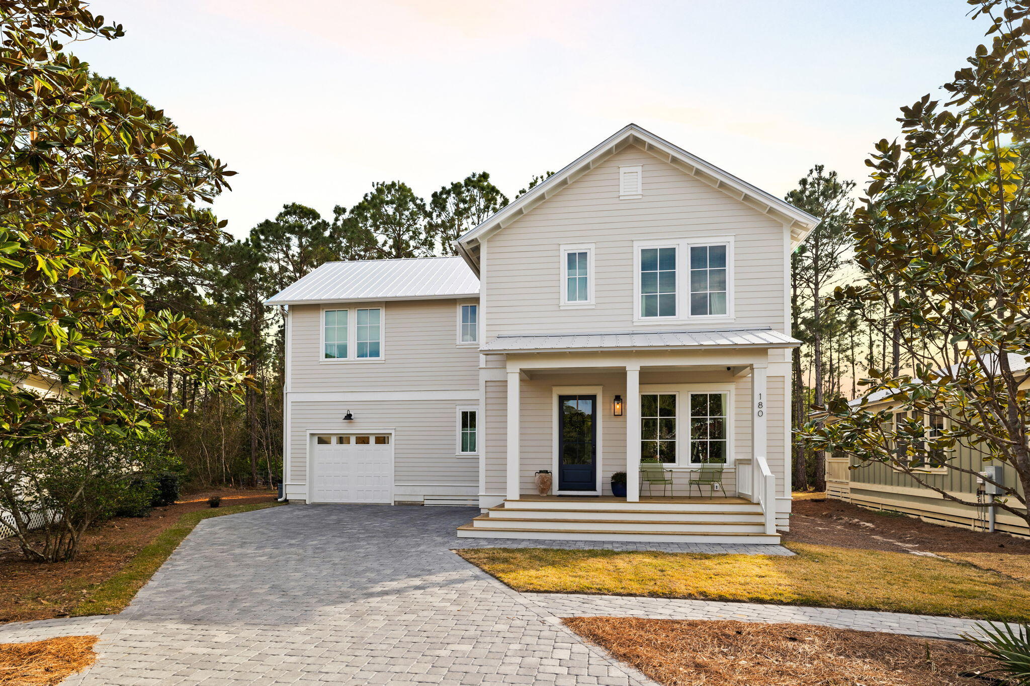 A stunning custom-built home nestled on a serene state preserve in gated Hidden Grove offers the perfect blend of luxury, privacy, and nature. This spacious four-bedroom residence is designed to maximize both comfort and the breathtaking views of the surrounding landscape. A paver driveway lined with a variety of trees and shrubs leads to a builder-owned haven designed with upgrades galore and modern living in mind. Large windows flood the home with natural light, enhancing the impeccable attention to detail and thoughtful finishes. The gourmet kitchen boasts top-of-the-line Monogram appliances including a six burner gas range and custom hood, cabinets and tilework to the ceiling, and an adjacent butler's pantry with solid granite countertops and backsplash to provide additional storage and