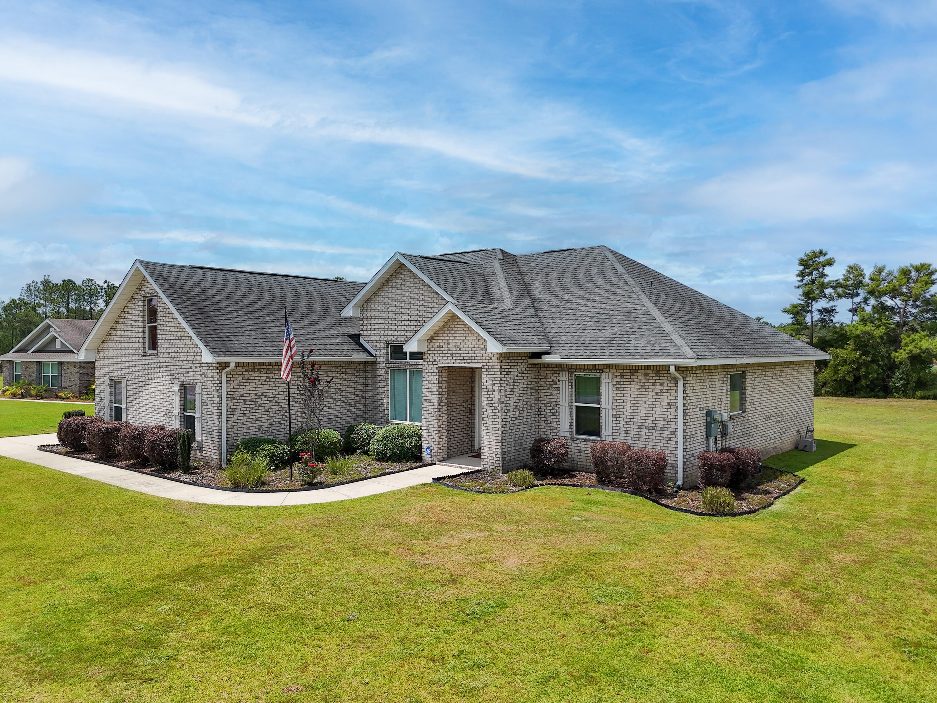 Take advantage of a rare VA assumable loan at just 3.5% (approximately $426,000 balance, subject to VA eligibility and lender approval). This custom-built 4-bedroom, 2-bath home is ideally situated on a quiet cul-de-sac in the sought-after Windswept Dunes Golf Community, offering minimal through traffic and added privacy. Nestled on a spacious .63-acre lot, there's plenty of room to build the backyard pool of your dreams. Inside, you'll find all new luxury vinyl plank flooring, fresh interior paint, and new stainless steel kitchen appliances, making this home truly move-in ready. The gourmet kitchen features custom cabinetry, a large quartz island, and abundant prep space for entertaining. The private primary suite boasts an oversized tiled shower and an impressive walk-in closet. Upstairs, the large bonus room over the garage offers endless flexibility as a media room, home office, playroom, or guest retreat. Step outside to the covered back porch where the hot tub conveys, creating the perfect place to relax after a long day. Residents enjoy resort-style amenities including a clubhouse, swimming pool, tennis and pickleball courts, playground, food truck nights, community events, and a championship golf course. Don't miss this incredible opportunity to own a beautifully updated custom home with an unbeatable assumable interest rate!