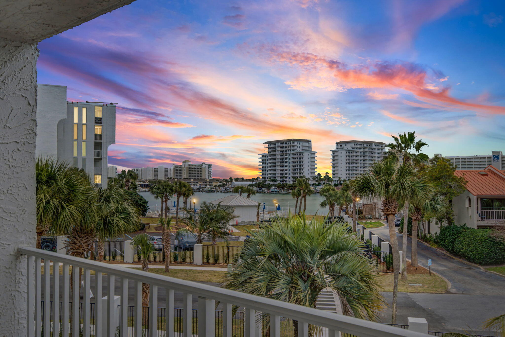 Wake up to shimmering harbor views and effortless coastal elegance in this beautifully updated 2-bedroom, 2-bathroom waterfront condo located in the highly sought after Dolphin Point Condominium on Holiday Isle.

Perched on the third floor, this immaculate residence captures the essence of Destin Harbor living, where every day feels like a getaway.

Floor to ceiling windows fill the living space with natural light and frame breathtaking views of the harbor, seamlessly extending your living area onto a private balcony--the perfect spot for morning coffee or sunset reflections.

Travertine marble tile flooring throughout creates a refined, cohesive look while offering easy, low maintenance living with no carpet.

Meticulously cared for, this condo is ideal as a full-time residence, part ti Your invitation to the waterfront lifestyle you've been dreaming of.
Imagine waking up every single morning to the sight of sunlight shimmering across Destin Harbor.

Welcome to Dolphin Point on Holiday Isle--where effortless coastal elegance meets the laid-back rhythm of the Gulf, and every day genuinely feels like a getaway. Perched beautifully on the third floor, this immaculate 2-bedroom, 2-bathroom waterfront sanctuary captures the absolute best of Destin living.

Sun-drenched elegance & refined spaces, step inside and let the outside in. Floor-to-ceiling windows flood the open living space with natural light, framing breathtaking harbor views that pull you toward your private balcony. Whether it's with your first cup of morning coffee or a glass of wine at sunset, this is your front-row seat to coastal paradise.

Fresh & modern, the living area and primary bedroom are currently being painted a crisp, luminous white, offering a clean, modern canvas for your personal style.

Timeless finishes, exquisite Travertine marble tile flows seamlessly throughout the entire home. It's a refined, sophisticated look that offers the ultimate luxury: easy, low-maintenance living with absolutely no carpet.

Unmatched storage, convenience is built right into the lifestyle. This unit features one of the largest private owner's closets down the hall--perfect for effortlessly tucking away your bicycles, beach chairs, and paddleboards.

A community infused with energy and leisure, Dolphin Point isn't just a place to live; it's a vibrant, beautifully maintained community designed to elevate your lifestyle. The exterior has been newly restored and painted, the clubhouse beautifully remodeled for entertaining, and the special assessment has already been paid in full by the seller, giving you total peace of mind.

Indulge in a collection of amenities that rival any resort, dip into the sparkling heated pool, play a match on the freshly resurfaced pickleball and tennis courts, launch your paddleboard from the community storage or lounge on the private, sandy harbor beach.

Hop on your bike for a short, scenic cruise to the world-famous, sugar-white sands and emerald-clear waters of the Gulf.

The ultimate Destin connection, when adventure calls, you don't even need a car. Simply step outside and hail a water taxi to whisk you away to Destin Harbor's vibrant waterfront dining and entertainment scene, or cruise over to Crab Island for an unforgettable afternoon on the water.

Whether you are seeking a permanent sanctuary, a part-time retreat, or a premier investment opportunity, this meticulously cared-for condo is more than just a home--it's the keys to a life well-lived.

Your harbor-front dream is waiting. Call or text today to schedule your private showing.  There is a boat slip currently available for rent at $800 per month.  

Updated photos showcasing the fresh, white paint coming soon! All information and measurements are deemed accurate but should be verified by the Buyer.