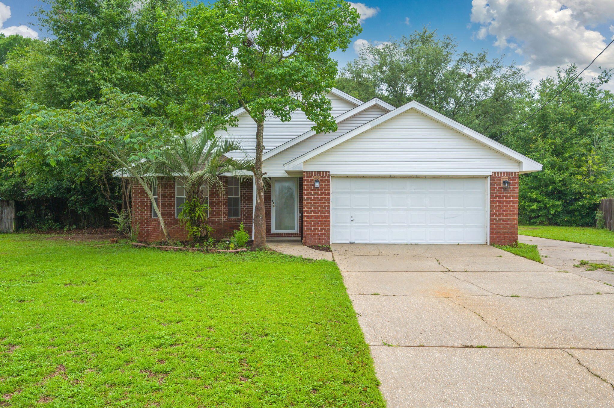 Your new home is a 3BR/2BA home in the established Cedar Ridge Estates on a large fenced lot with RV parking. New roof to be installed before closing and solar panels paid off, providing low electric bills - you can run that sweet cool AC and beat the Florida heat without breaking the bank.  Major system updates include HVAC (2024) and water heater (2024). Interior features a welcoming living room, eat-in kitchen, and a cozy den with fireplace. Primary suite includes double sinks and a walk-in closet. Home is priced to allow the buyer to make updates and add personal touches. Spacious yard offers room to garden, play, or expand.