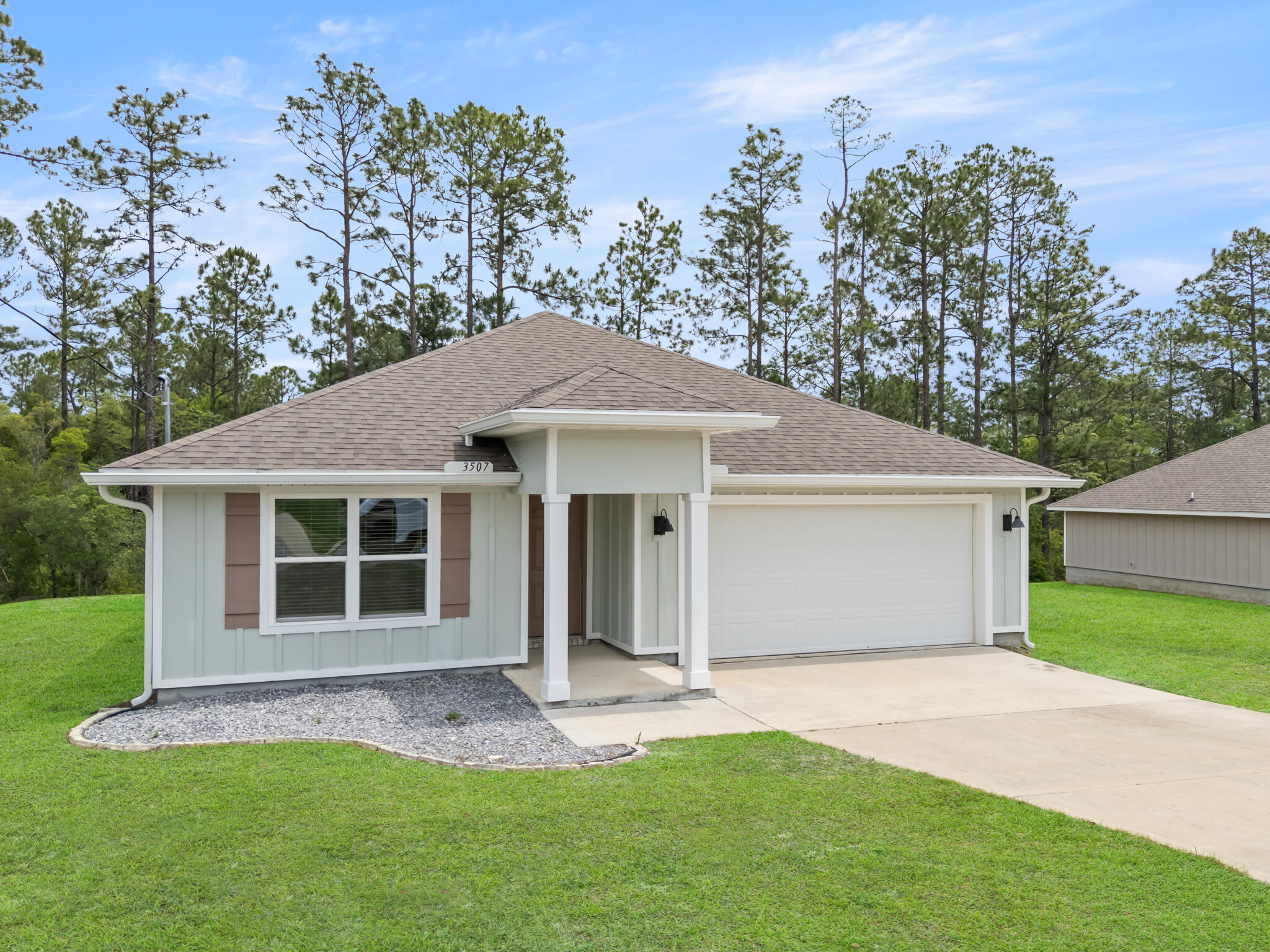 Built in 2022 and sitting on over a third of an acre, this property offers something that's becoming harder and harder to find -- space, privacy, and a backyard that stretches into the woods behind the home, creating a peaceful natural setting right outside your door.

As you step inside, the home immediately opens up with a bright and airy floor plan designed for both everyday living and entertaining. The engineered vinyl plank flooring flows throughout the main living areas, while the kitchen naturally becomes the heart of the home with its oversized island, stainless steel appliances, updated cabinet finishes, installed drawer pulls, and open sightlines into the living and dining spaces. Whether it's hosting family for the holidays, helping with homework at the counter, or enjoying a quiet morning coffee before the day begins, this home was designed for the moments that matter most.

Natural light pours through the windows, while blinds throughout the home and ceiling fans in every room add comfort and practicality already in place for the next owner.

The split bedroom design offers an ideal balance of privacy and functionality. Three guest bedrooms are positioned toward the front of the home, creating the perfect setup for family, guests, a home office, or hobby spaces. Tucked away near the back of the home, the primary suite becomes its own private retreat with a spacious ensuite featuring double vanities, a standalone shower, and not one, but two closets.

Step outside onto the covered back porch and you'll quickly understand what makes this property special. With the lot extending into the wooded backdrop behind the home, there's a sense of peace and separation that's hard to put into words. It's the perfect spot for slow mornings, weekend grilling, evening conversations, or simply enjoying the quiet surroundings after a long day.

Located in one of North Crestview's growing communities, this move-in ready Craftsman-style home blends modern convenience, thoughtful design, and the kind of setting that truly feels like home.