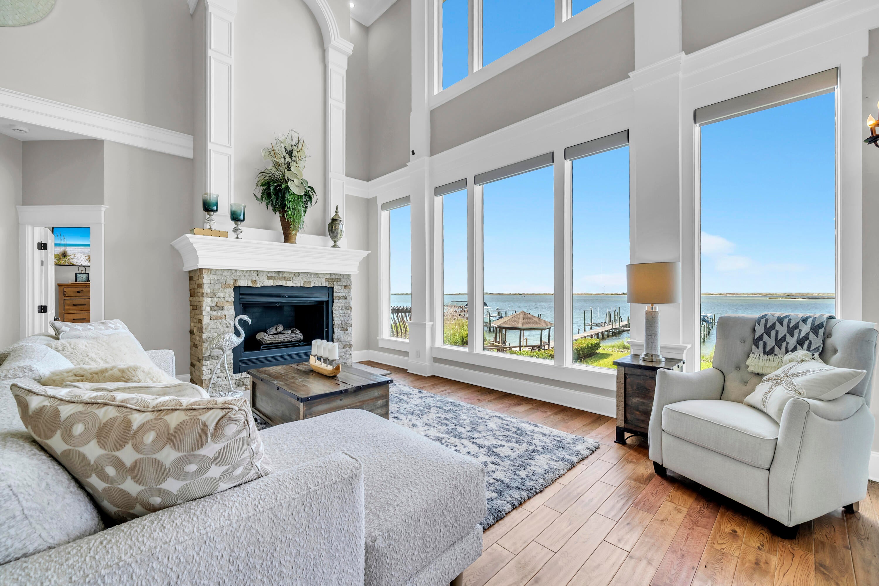 If spectacular vistas are important to you, there are few better. Impeccably maintained, this exceptional 3-bedroom, 3.5-bathroom residence with an office and versatile flex space offers panoramic views of the Santa Rosa Sound and Gulf from nearly every room. Set amid nature, the home features expansive living spaces, including a formal dining room, chef's kitchen, wet bar, two gas fireplaces, and both covered and open-air porches. The flex space, furnished with a queen bed, provides a comfortable retreat for overnight guests. A climate-controlled garage with a full bath, more than 1,000 square feet of covered space beneath the home for entertaining, private boat dock access, and proximity to a community swimming pool add to the appeal. Feel the evening breezes and take in breathtaking sunrises and sunsets while surrounded by an extraordinary aquatic wildlife habitat frequented by blue herons and dolphins. This one is special.