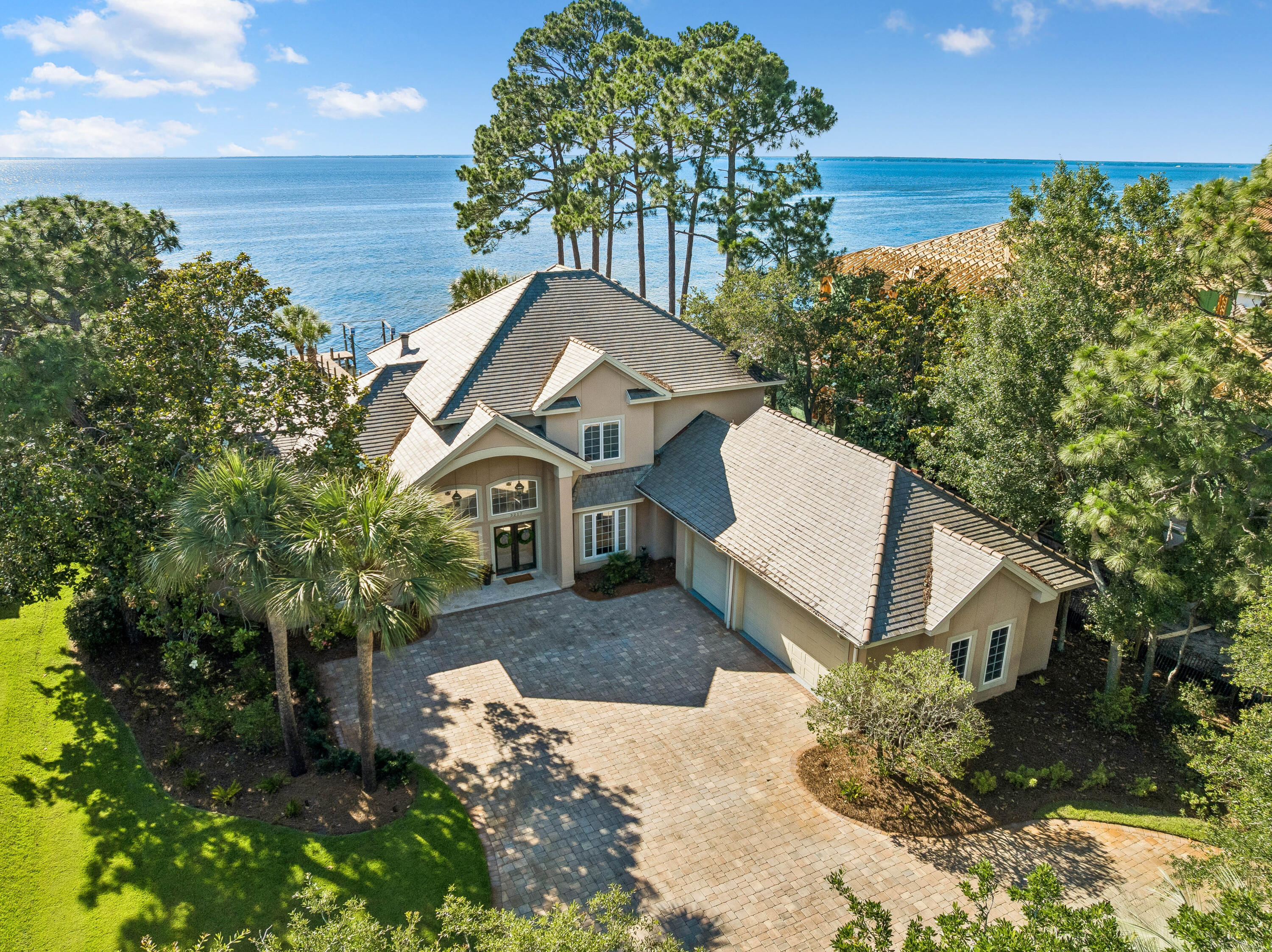 Bathed in natural light and framed by unforgettable sunsets, this bayfront estate doesn't just offer views, it redefines waterfront living. Situated on approximately one-half acre, this residence is designed to capture the beauty of its waterfront setting from nearly every room.
Spanning over 4,000 square feet, the home features soaring ceilings, and expansive floor-to-ceiling windows that frame panoramic bay views. The open living spaces flow seamlessly to the outdoor entertaining areas, creating an effortless connection between indoor and outdoor living.
The infinity-edge pool serves as the centerpiece of the backyard, blending into the waters of the bay beyond and providing a front-row seat to unforgettable sunsets and the ever-changing waterfront landscape. Whether enjoying a quiet morning overlooking the water or gathering with family and friends, the setting is both peaceful and inviting.
Located behind the gates of Burnt Pine, residents enjoy the security and exclusivity of one of Northwest Florida's most sought-after communities, with access to championship golf, resort amenities, marinas, dining, and the white sand beaches of the Emerald Coast just minutes away.
An exceptional opportunity to experience waterfront living within Sandestin's premier residential community.