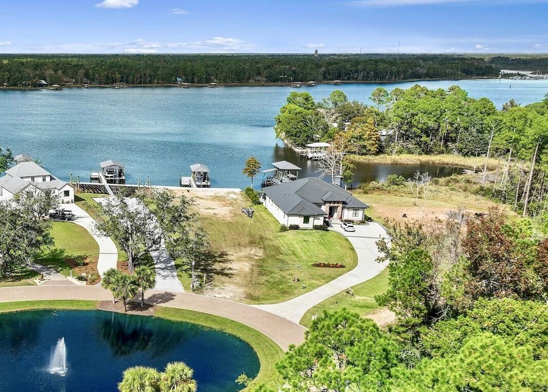 Boating & Fishing HEAVEN! Waterfront, custom-built home with 10,000lb boat lift, waverunner lift, pro cleaning station and covered fire pit nestled in the safe haven waters of Lagrange Bayou.  Easy access to the Bay and quick ride to the Gulf Pass.  3B/3B with dedicated office and a bonus room currently being used as a second office that can easily be converted to a 4th bedroom.  Enjoy spectacular waterviews from the comfort of your open living/kitchen/dining plus an incredible 20x37' screened lanai with adjacent covered, outdoor kitchen. Contemporary brick and hand-laid stone with cypress accents, slate metal roof, wood-look tile floors, three-stage crown molding...every attention to detail is found in this custom Builder's home. Schedule a private showing today.  Bayou tour available by request.