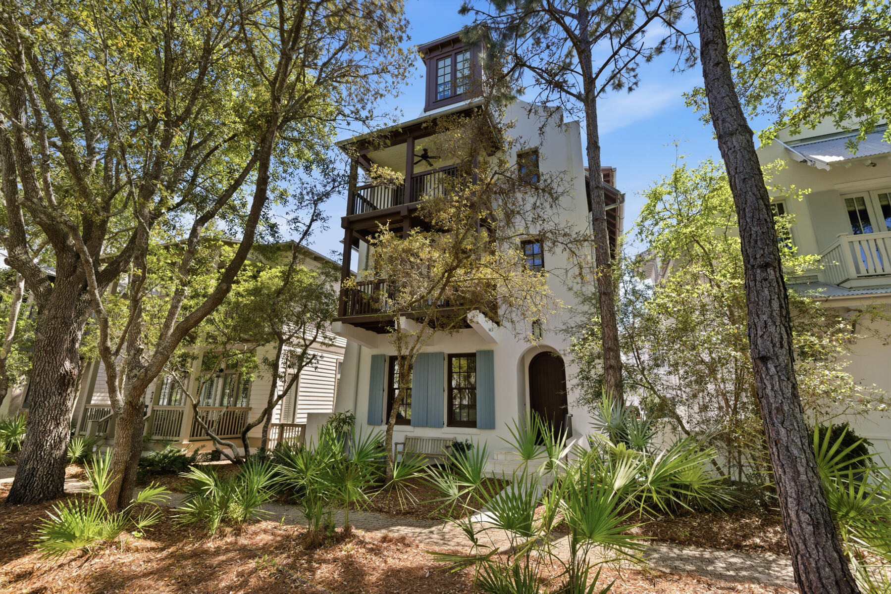 Designed by award-winning architect Tim McNamara, 87 Bridgetown Avenue is a rare large-format family retreat ideally positioned on one of the quietest and most desirable streets in Rosemary Beach. Thoughtfully designed for multigenerational living and effortless entertaining, this exceptional courtyard residence combines architectural character with the practical functionality rarely found in Rosemary Beach.  Spanning approximately 4,380 square feet, the property offers expansive gathering spaces, multiple indoor and outdoor living areas, elevator access to all levels, and exceptional sleeping accommodations for large families and guests. The main residence features three spacious king suites with private en suite baths, each complemented by its own private balcony, creating peaceful retreats throughout the home. A second-floor bunk area provides additional accommodations ideal for children or overflow guests, while the inviting living and dining spaces are designed for comfortable long-term stays rather than simply weekend occupancy. The first-floor living area is further enhanced by a warm and inviting wood-burning fireplace.  Encompassing the entire third floor, the luxurious approximately 1,251-square-foot primary suite serves as a true private retreat, offering exceptional scale, privacy, and comfort rarely found in Rosemary Beach. The suite provides an elevated owner experience while maintaining separation from the home's guest and family gathering areas, and includes a spacious spa-inspired bath featuring a relaxing Jacuzzi soaking tub. Additional features of the primary suite include a private wet bar with mini refrigerator and a gas log fireplace, creating a peaceful and luxurious owner sanctuary.  At the center of the home, the beautifully designed first-floor courtyard offers a private spa pool and inviting outdoor living space, creating an ideal setting for entertaining, relaxing after the beach, or enjoying quiet evenings with family and guests. The courtyard is anchored by an outdoor fireplace and a fully appointed outdoor kitchen featuring a Viking gas grill, sink, and mini refrigerator.  Above the detached two-car garage, the carriage house creates a true private guest retreat with an additional king bedroom, bunk room, full bath, half bath, kitchenette, and its own private balcony--perfect for extended family, grandchildren, visiting guests, or private owner accommodations.  One of the home's most valuable and increasingly rare features is its exceptional parking capacity. The property comfortably accommodates four private on-property parking spaces, including a two-car garage and two additional off-street spaces behind the garage, while also benefiting from unusually favorable street parking along quiet Bridgetown Avenue.  Ideally situated near several of Rosemary Beach's most desirable owner amenities, the home enjoys close proximity to the Cabana Pool, the Owner's Pool, and the exclusive Owner's Pavilion--offering exceptional convenience for families, children, and guests while maintaining a peaceful and less congested setting within the community.  The location also provides easy access to the Town Center, St. Augustine Green, shopping, dining, and the beach, creating an ideal balance of privacy, walkability, and resort-style living.  Rich architectural details including Brazilian walnut hardwood flooring, pecky cypress millwork, multiple porches, and beautifully integrated outdoor spaces further distinguish this exceptional property. Rarely does a Rosemary Beach home combine this level of scale, functionality, parking, flexibility, and family-oriented design in such a premier location.
