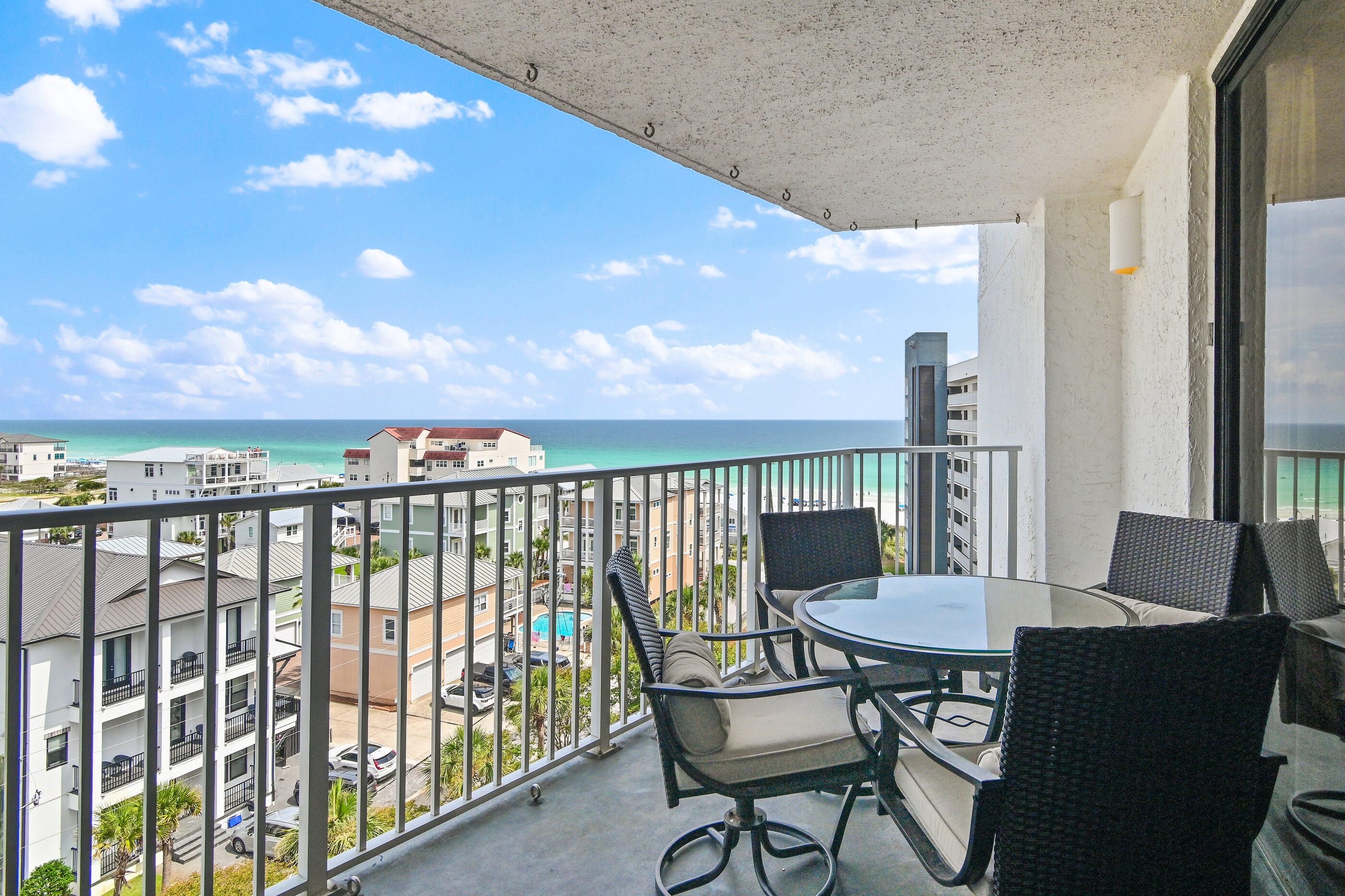 Gorgeous two bedroom, two bathroom turnkey condo offering 1,040 square feet of completely upgraded living space and breathtaking panoramic views of the Gulf, and coastline. This pristine residence features premium tile flooring and upscale furnishings throughout. The open-concept living area maximizes the stunning water views and provides seamless access to the private balcony. In the kitchen, you will find granite countertops, stainless steel appliances, a modern tile backsplash, and an induction cooktop. The spacious master suite serves as a private retreat with its own balcony access, dedicated dressing area, and a custom tile shower complete with a built-in bench. Recent updates include fresh paint throughout, new outdoor furniture and repairs throughout. The property also includes two highly convenient exterior storage units for all your beach gear. Located in the premier gated community of Mainsail, residents enjoy twenty four hour security, covered parking, two sparkling pools, tennis courts, and seven hundred feet of private beach front access.