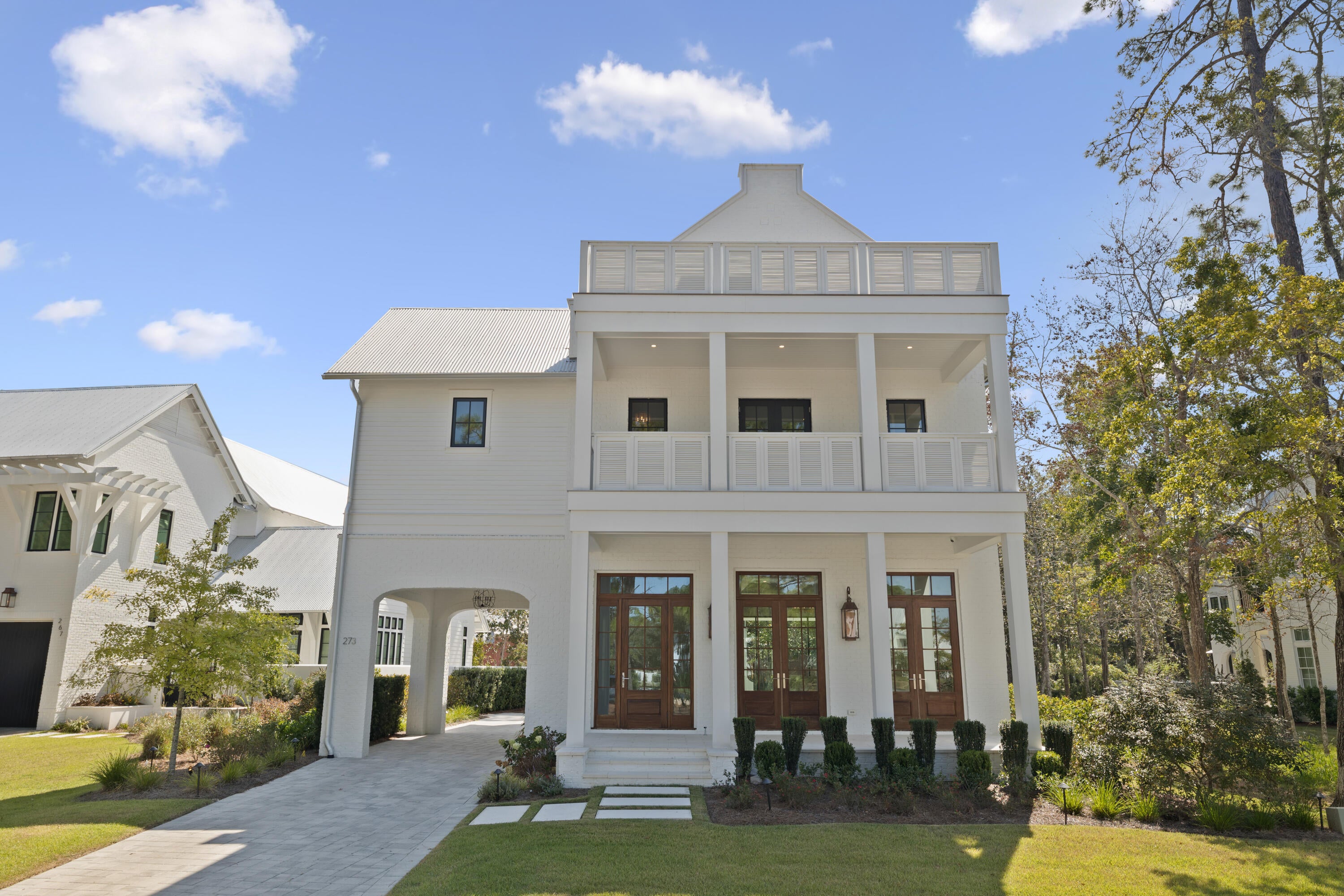 Set within the private gates of Churchill Oaks, 273 Churchill Oaks Drive blends thoughtful design, versatile living, and effortless access to the coastal lifestyle. Located in this premier bayfront community, the home offers over 4,000 square feet of refined living space, including four bedrooms, four-and-a-half bathrooms, and a private carriage house--perfect for guests, extended family, or a dedicated home office. The spacious great room, anchored by a gas fireplace and framed by an abundance of windows and doors, sets the tone for the home's mix of traditional elegance with modern touches.
