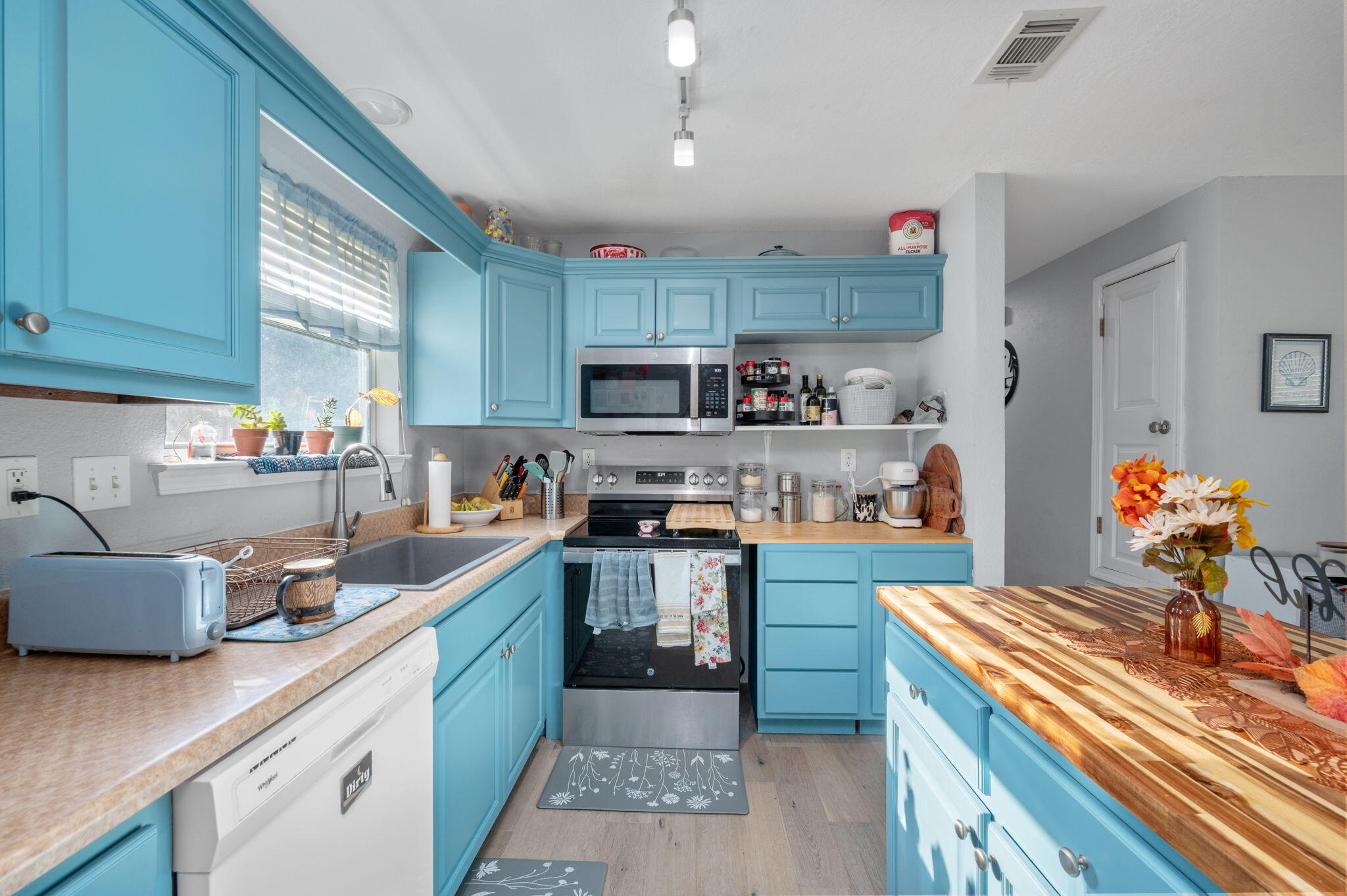 OH MY GOSH!! You have to see this!!! This Ranch-Styled Home on 0.49 acres has a 29X29 Pole Barn/Workshop, 12X24 Insulated & Electric Shed, a beautiful Greenhouse, AND a 10X10 Storage Shed. This 3-Bed and 2-Bath home features an open floor living area with UPGRADES throughout the home. The kitchen is spacious with beautiful painted cabinets and an ADDED island (2026). Enjoy your morning coffee on the paved and covered back patio with a FULLY fenced-in backyard. Grow your favorite fruits and vegetables in the greenhouse, on the vines, or trees that are already there! There are orange, banana, and lemon trees. New stove and Microwave - 2025, New Water Heater- 2026, HVAC - 2019, Roof- 2018, New Flooring and Paint - 2024