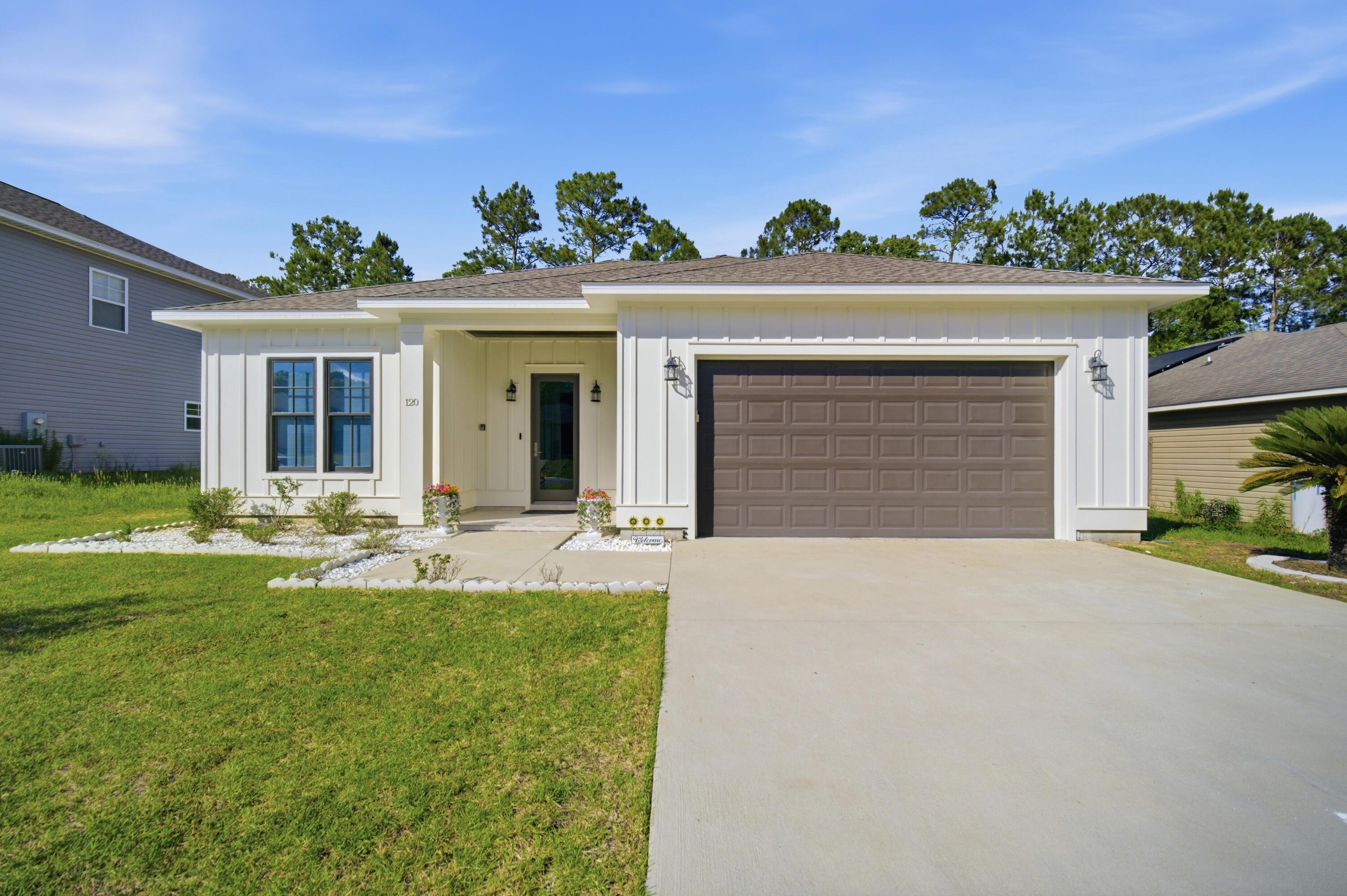 Welcome to 120 Lillian Way -- where modern luxury, quality construction, and everyday comfort come together in one exceptional home located in the highly sought-after Taylor Farms community of Crestview. Built in 2022, this beautifully designed Craftsman-style residence offers the perfect blend of upscale finishes, energy-efficient features, and functional living spaces that today's buyers are searching for.

From the moment you walk through the front door, you are immediately greeted by soaring ceilings, abundant natural light, and an open-concept layout designed to impress. The living room, dining room, and primary suite feature stunning 11-foot ceilings that create a grand and spacious atmosphere, while the remainder of the home offers elevated 10-foot ceilings throughout -- a rare feature that truly sets this property apart from others in the area. Oversized 8-foot interior doors further enhance the luxurious feel of the home and add to its custom-built appearance. Designed with both elegance and durability in mind, the home features ceramic tile flooring throughout, providing a clean, seamless look with easy maintenance and long-lasting quality. The spacious living area flows effortlessly into the beautifully appointed kitchen, creating the ideal space for entertaining guests, hosting family gatherings, or simply enjoying everyday life. The kitchen offers modern cabinetry, stainless steel appliances, ample counter space, and a large island perfect for meal prep, casual dining, and entertaining.

The primary suite is a true retreat, offering privacy, comfort, and upscale finishes throughout. The spa-inspired primary bathroom showcases a gorgeous marble walk-in shower, double vanities, and a spacious layout designed to provide both luxury and functionality. Every detail of this home reflects quality craftsmanship and thoughtful design.

Beyond its beauty, this home was built to perform. Foam insulation throughout provides exceptional energy efficiency and helps reduce utility costs year-round, while hurricane-impact windows and doors offer added protection, security, and peace of mind during Florida's storm season. An electric vehicle charging outlet has already been installed, making the home future-ready for modern living. The spacious double-car garage provides ample storage and convenience.

Located just minutes from I-10, PJ Adams Parkway, shopping, dining, schools, and military bases, this home combines peaceful neighborhood living with easy access to everything Crestview has to offer. Whether you are looking for your forever home, upgrading to newer construction, or searching for a property with premium upgrades already included, 120 Lillian Way delivers unmatched value, style, and comfort.