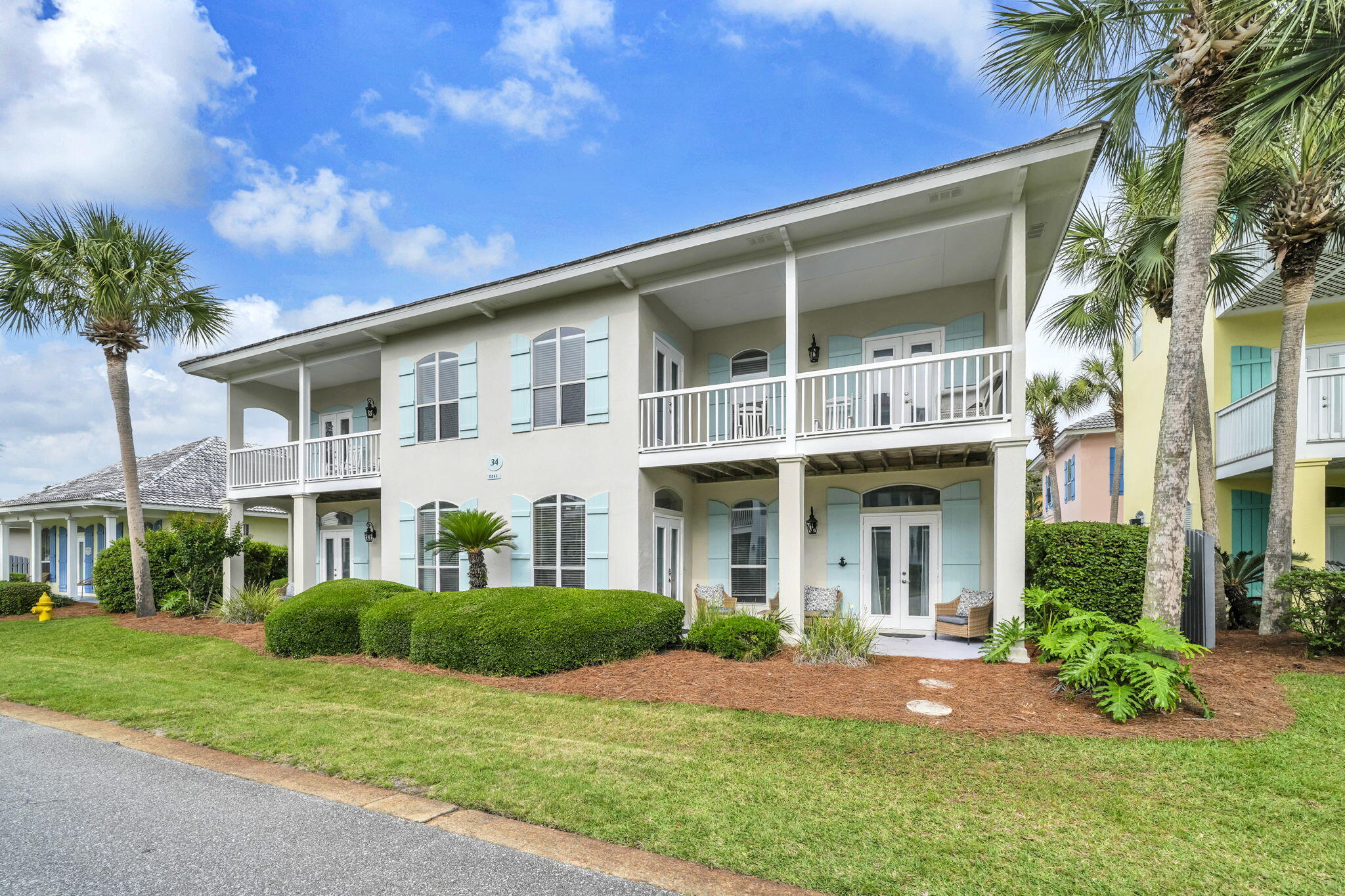 Discover the charm of coastal living at 34 Opal Cove. Located just 1,100 feet from the white sand beaches of the Emerald Coast, this is a beautifully updated, fully furnished home in the gated Emerald Shores community of Miramar Beach. With almost 2,100 sq ft of living space, this two-story property features a recently renovated kitchen, fresh exterior paint, updated light fixtures, two ensuite bedrooms (one on each floor), a third bedroom with patio access, a bunk room, and two separate living areas--one with its own kitchenette.
The fenced backyard, outdoor grill, and four covered porches create inviting spaces for outdoor living. Community amenities include two pools (one heated), tennis courts, private beach access with a pavilion, restrooms, showers, seasonal tram service, beach chair rentals.