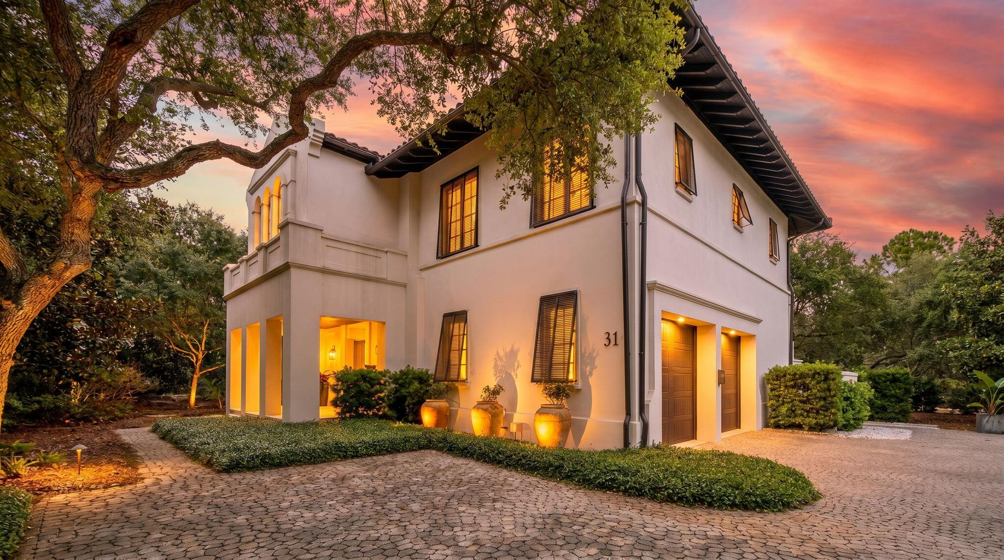 Tucked beneath a canopy of majestic Southern live oaks, this exceptional coastal residence is gracefully positioned on a large homesite with mature landscaping within an exclusive gated enclave near Little Redfish Lake. Just a short stroll from the Gulf with private deeded beach access, the property embodies the perfect balance of luxury, privacy, and relaxed coastal living.

Built in 2016, this thoughtfully designed 5-bedroom, 7-bathroom home spans 4,837 square feet and showcases refined craftsmanship paired with seamless indoor-outdoor living. A welcoming mahogany entry opens to sophisticated interiors and inviting entertaining spaces designed to embrace the surrounding natural beauty.

The heart of the home flows effortlessly into a stunning outdoor retreat featuring a heated pool, tranquil courtyard spaces, and multiple lounging areas framed by lush mature landscaping and towering live oaks. A spacious loggia with retractable screen, a summer kitchen, and one of three fireplaces creates the ultimate setting for year-round entertaining.

Each bedroom offers generous accommodations and private comfort, while additional luxury features include a private elevator, three fireplaces, and a spacious two-car garage. Located within a private, rental-restricted community, this remarkable residence offers an unparalleled opportunity to enjoy an elevated coastal lifestyle with exclusive beach access, exceptional privacy, and timeless coastal elegance.