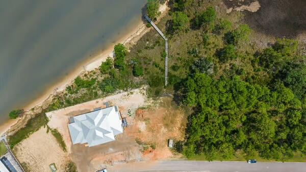 BAYFRONT BEAUTY IN A GATED WATERFRONT COMMUNITY! Rare opportunities like this don't come along often. This exceptional cleared homesite is ready for your dream home, complete with approximately 80 feet of bay frontage, a 140-foot private boardwalk already in place, and underground utilities, saving you both time and expense.

Perfectly positioned within the exclusive gated community of Sea Pines, this spectacular property offers breathtaking panoramic bay views and unforgettable sunsets. A sandy beach area along the shoreline and the picturesque marsh beneath the boardwalk create the timeless charm of Old Florida while providing a serene setting for boating,fishing, kayaking, paddleboarding, birdwatching, or simply relaxing by the water.

Surrounded by beautiful custom waterfront homes, Sea Pines offers the privacy and tranquility you've been searching for, yet is conveniently located with quick access to I-10 and the Garcon Point Bridge, giving you easy access to area shopping and providing for quick commutes.

Whether you're ready to build your forever home or waterfront getaway today, or you're looking to secure a premium bayfront property as a long-term investment, this is an outstanding opportunity to own one of Northwest Florida's most desirable waterfront homesites. One owner is Licensed Real estate broker.