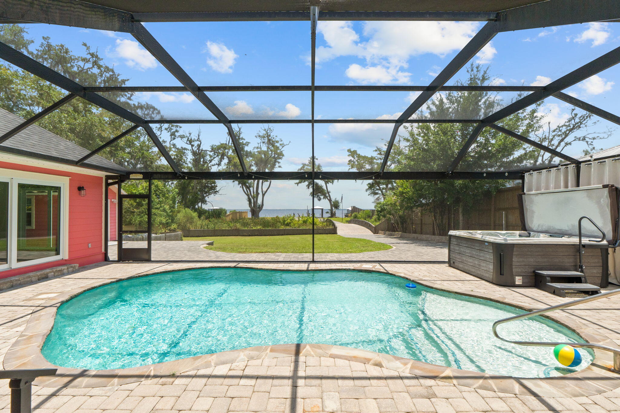 **MAJOR PRICE CORRECTION**

Waterfront multigenerational dream home on half an acre, all on one level and fully fenced for privacy, security, and fun. This rare property offers two separate homes, a covered pool, private dock, and tons of parking--perfect for a large family, multi-gen living, or a primary residence with incredible Airbnb/short-term rental potential.

The main home is a spacious 3 bedroom, 2 bathroom layout with easy, single-level living, water views and includes a true mother-in-law suite with its own full kitchen, bathroom, and private access that leads directly out to the covered pool area--ideal for extended family, guests, or income-producing space. The second home is also a 3 bedroom, 2 bathroom layout. Multiple living areas, split bedrooms, and separate entrances give everyone room to spread out while still feeling connected.

Step outside to your own private resort: a screened/covered pool just steps from both homes, a private dock for boating, fishing, or paddleboarding, and a fully fenced yard with privacy fence and gated entry. The oversized lot (approximately half an acre) offers room for kids, pets, toys, and gatherings, with ample driveway space and parking for cars, RV, or boat. This is an entertainer's paradise and a true lifestyle property--waterfront living, no stairs, multiple kitchens, and flexible spaces that can adapt as your needs change.