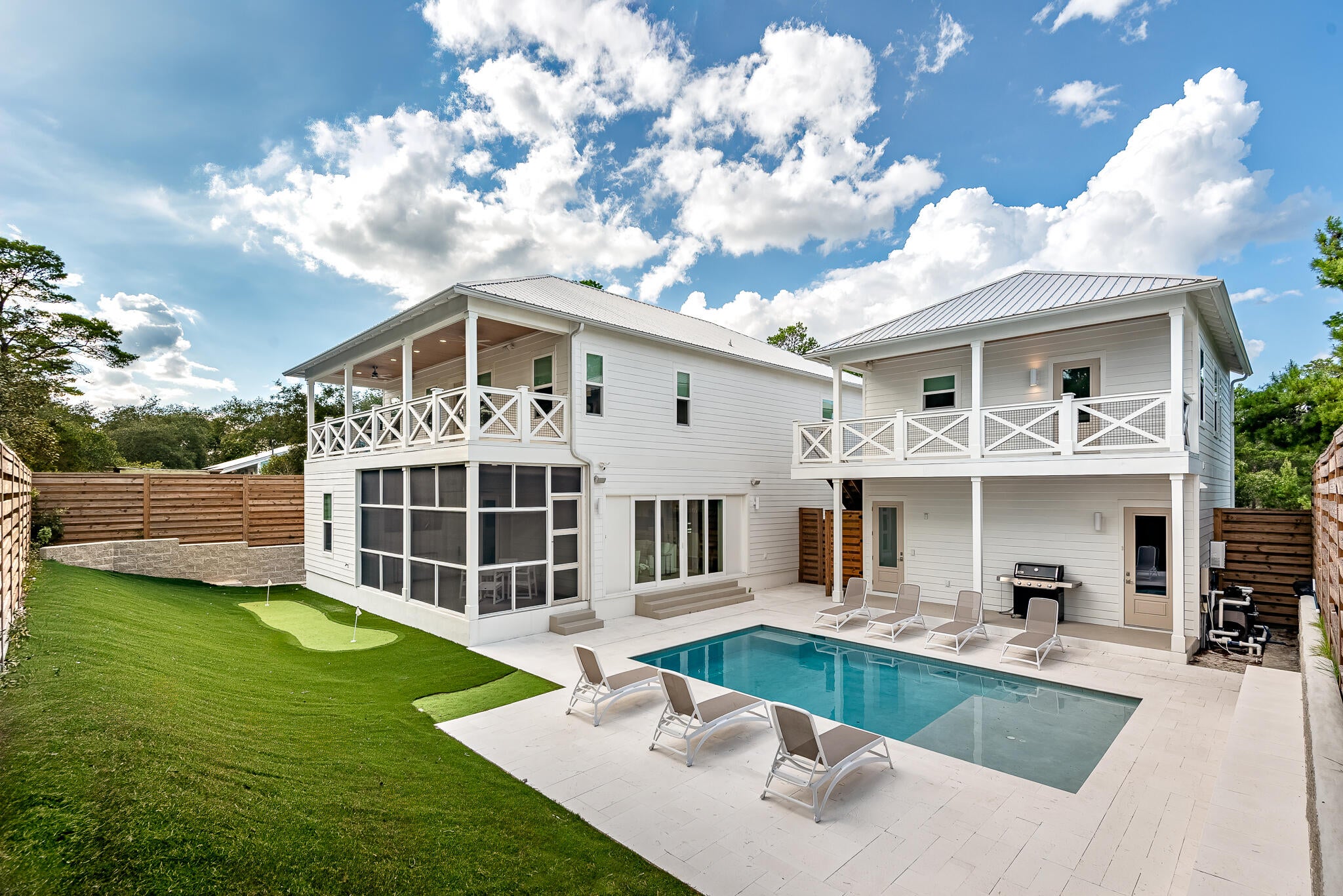 A rare opportunity in the booming Blue Mountain Beach area of 30A, for the family looking to live at the beach or for anyone looking to leverage the rental potential of a large home, 90 Oak Hill Lane is no-brainer to buy.  A recently built and beautifully decorated home, it is elegant in its ability to please the crowds, as well as give guests a quiet respite among its many living spaces.  

A compound in the true sense, 7 bedrooms are spread across two floors and an oversized carriage house.  Central to the property is an ample-sized pool with excellent sun exposure and a travertine pool deck.  Guests enjoying an evening after a day on the course can settle a 19th hole bet, putting barefoot at the poolside green.

Entertaining is easy, with a great room that accesses the pool by way of large sliding doors, and a gourmet kitchen featuring a 48'' gas stove and range.  Smart entertainment is available throughout the main living area with surround sound.  An upstairs game room greets you at the top of the stairs.

The first floor primary suite boasts a spa style owner's bathroom, which leads to an enormous walk-in closet.  5 of the guest rooms enjoy an en suite or dedicated bathroom, while a downstairs guest room makes the most of its space with 4 custom carpentry bunks.  

This is a like-new build with countless features that needs to be seen to be fully appreciated.