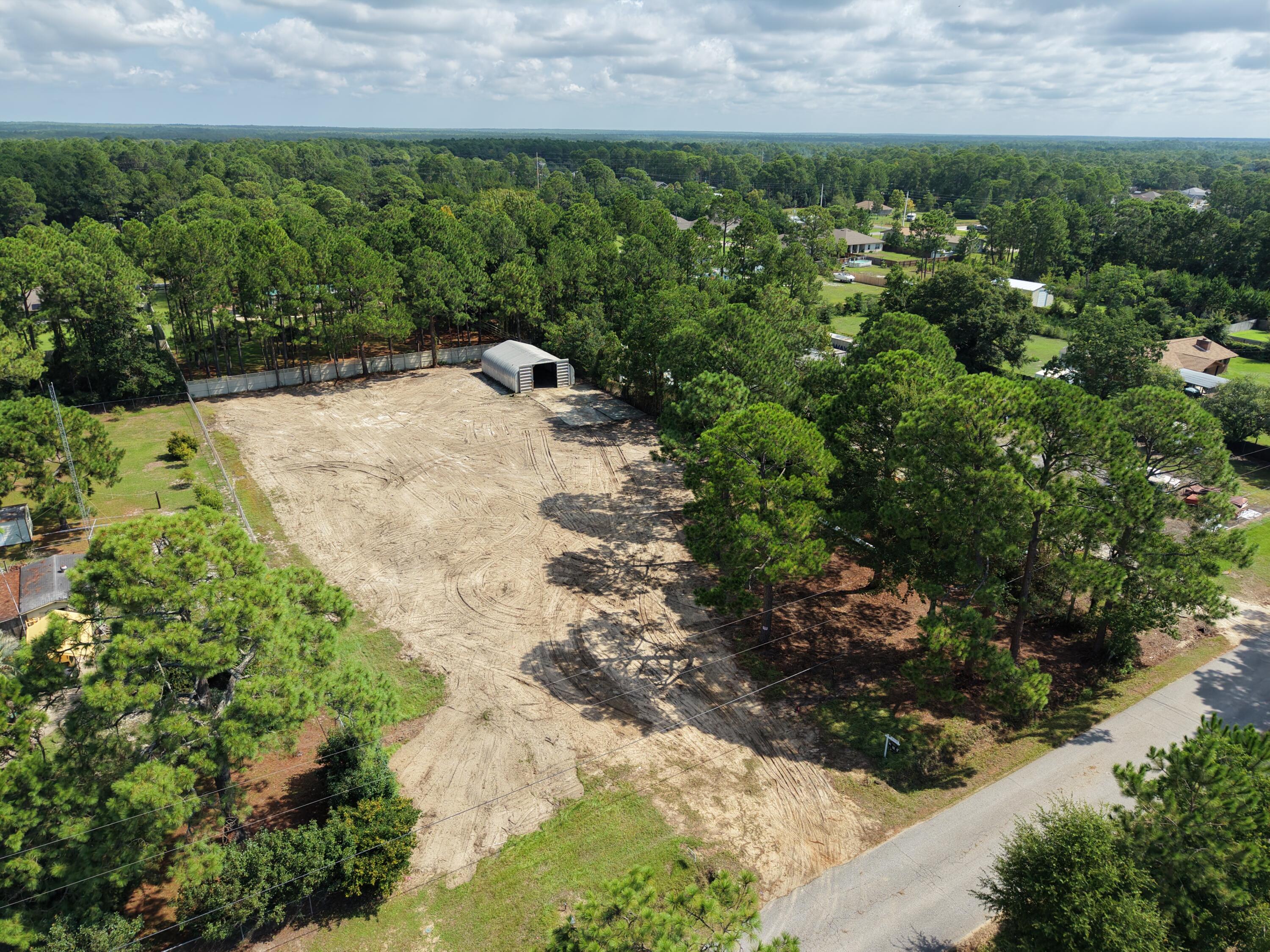 RARE 1.1-ACRE BUILD-READY OPPORTUNITY IN NAVARRE! 

Build the home you've been picturing. Keep the boat and RV at home instead of paying to store them. Turn the existing 30x40 steel building into the workshop you've always wanted. Add a pool, create an outdoor entertaining space, plant a garden, or simply enjoy having room around you.

At 9138 Quail Roost Drive, you aren't starting with raw, untouched land. The property has already been cleared, while a few mature trees remain across the front to give you a head start on creating a beautiful homesite. The water meter and access culvert are installed, fencing is already in place on three sides, and city sewer, electricity, and fiber are available.

And that 30x40 Quonset steel building? It's already sitting on a concrete slab, ready to become part of whatever you create here.

No HOA. Flood Zone X. No wetlands. Fewer obstacles between buying the land and bringing your plans to life.

Want to think bigger? The property has already been surveyed, split, and county-approved into two approximately .55-acre homesites, opening another completely different set of possibilities.

One homesite with room to spread out. Two separate lots. Build now, hold one for later. There's more than one way to make this property work.

The land is ready. Now bring the vision.