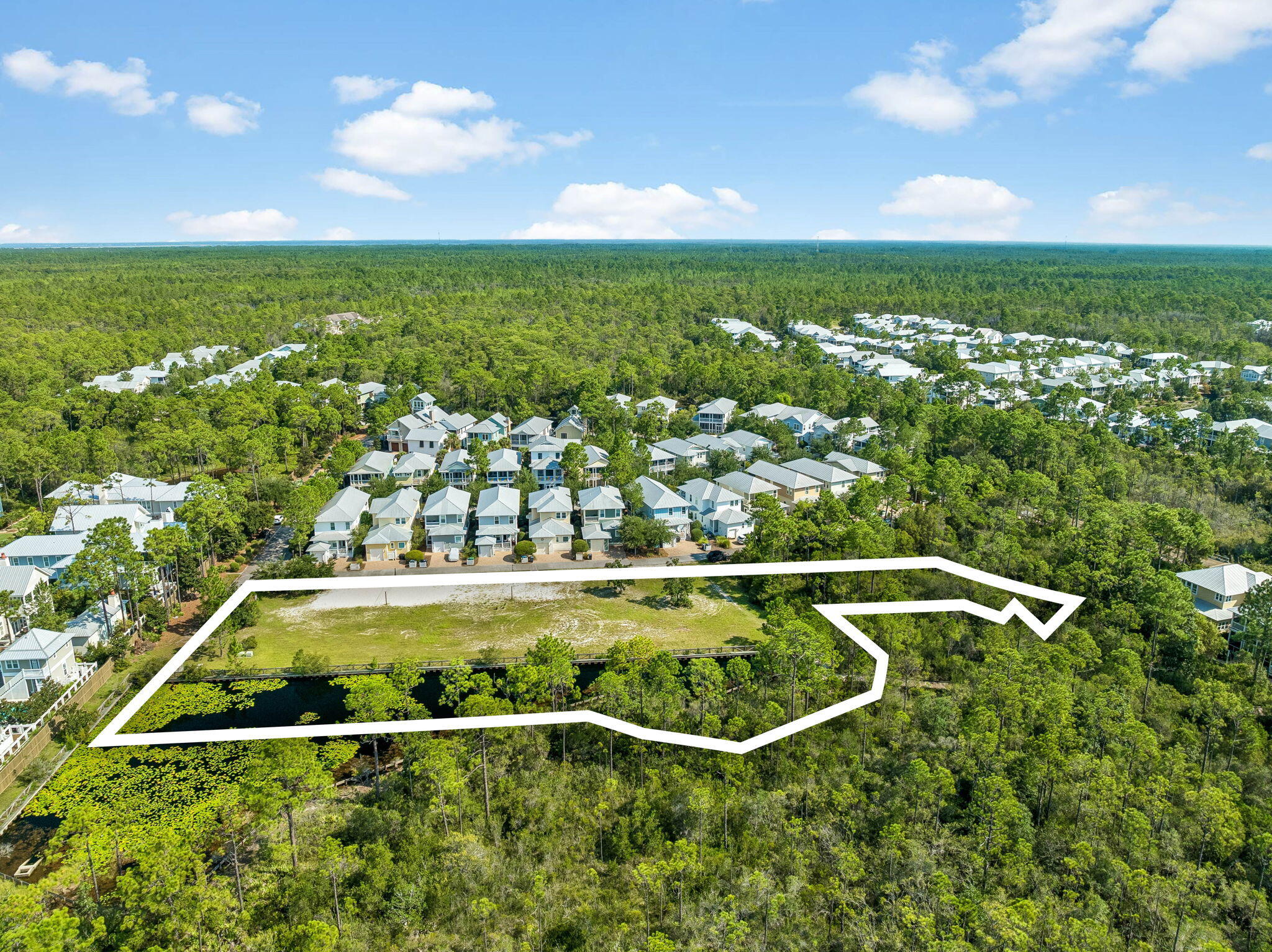 A rare development opportunity in the heart of 30A. This 1.57-acre tract will convey with a development order for six single-family residences, opening the door to the first new construction in years inside one of South Walton's most established master-planned communities. The site is in a flood zone "X," level, cleared, and fronts a paved interior street lined with existing homes. The six lots are laid out along that frontage, with the balance of the tract running back to a quiet lily-pad lake and a wooded preserve buffer to the east. Each lot enjoys views over the pond and no build-out behind them.

The CDD bond has been paid off. The developer has the opportunity to join the NatureWalk HOA. An exceptional play for an investor or builder looking for scale in a market with almost no remaining infill.

NatureWalk sits on 155 acres bordered by Point Washington State Forest, roughly a mile from the Seagrove public beach accesses and a short golf cart or bike ride to Seaside and WaterColor. WaterColor Crossings, with Publix, dining, and shopping, is minutes away. Residents enjoy The Gathering Place, a private amenity center with a zero-entry resort pool, heated lap pool, kiddie pool, hot tub, fire pit, grills, and playground, plus miles of nature trails and a seasonal beach shuttle.