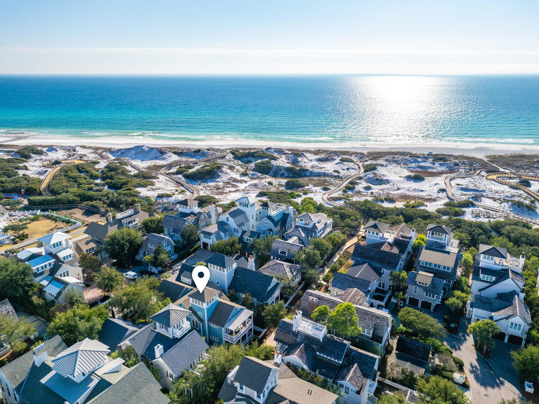 Located in the highly sought-after gated community of Watersound Beach, 90 S. Founders Lane is a stunning coastal sanctuary positioned on the 3rd row  from the beach along a pristine mile-long stretch of private beaches and more than seven miles of scenic boardwalks. Ideally located just 100 steps down the Coopersmith East Boardwalk to the sugar-white sands and emerald waters of the Gulf, while another short 100-step stroll brings you to the community pool and popular Dunesider Grill. Thoughtfully designed for both relaxed coastal living and entertaining, this beautifully appointed residence offers an open-concept floor plan with timeless architecture, designer finishes, hardwood flooring, and inviting indoor and outdoor gathering spaces. Designed with a reverse floor plan to enhance views and maximize natural light. The home features primary bedroom suites on both the first and second floors, providing flexibility and privacy for owners and guests alike. Additional highlights include a third-floor bonus space currently used as a game room, a fourth-floor widow's watch showcasing Gulf views, and a detached carriage house ideal for guests or additional living space. Expansive porches and outdoor living areas embrace the coastal lifestyle, while lush landscaping enhances the home's private setting.

Offered fully furnished, this exceptional property provides a turnkey opportunity to enjoy the very best of WaterSound Beach living, with access to resort-style amenities, scenic trails, private beach access, and the unmatched beauty of 30A.