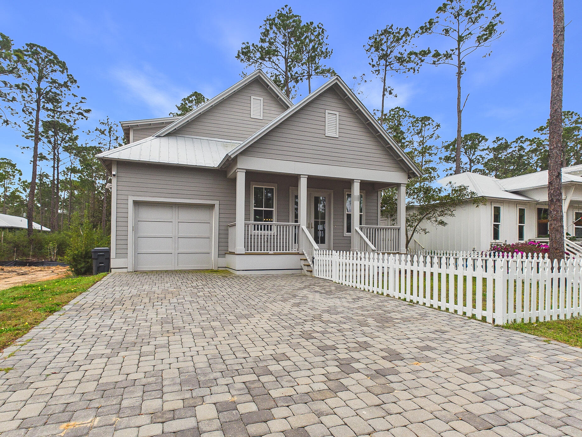 *Under contract with a 72-hr kickout clause in place* Discover coastal charm and modern luxury in this stunning Point Washington cottage, located in a premier community of full-time residents just minutes from the beaches of South Walton, where flood insurance is not required! A brick paver driveway and inviting front porch welcome you into a light-filled interior featuring durable luxury vinyl plank flooring and an open floor plan. The chef-inspired kitchen is a true highlight, boasting quartz countertops, shaker-style cabinetry, and upgraded stainless steel appliances including a gas range with a professional pot filler. The main-level primary suite offers a private retreat with a spa-like bath, while a whole-home water filtration system and a built-in workstation add everyday convenience. Designed for the quintessential Florida lifestyle, the exterior living spaces are perfect for entertaining. Host summer cookouts on the expansive screened back porch, which features a fully equipped outdoor kitchen and grill area. The property is beautifully enclosed by a new white picket fence and includes a dedicated dog run for pet owners. Ideally located a short walk from Bay access, this home is perfect for those looking to live, work, and play near 30A. Whether you are seeking a primary residence or an investment, this property delivers, with rental projections available upon request.