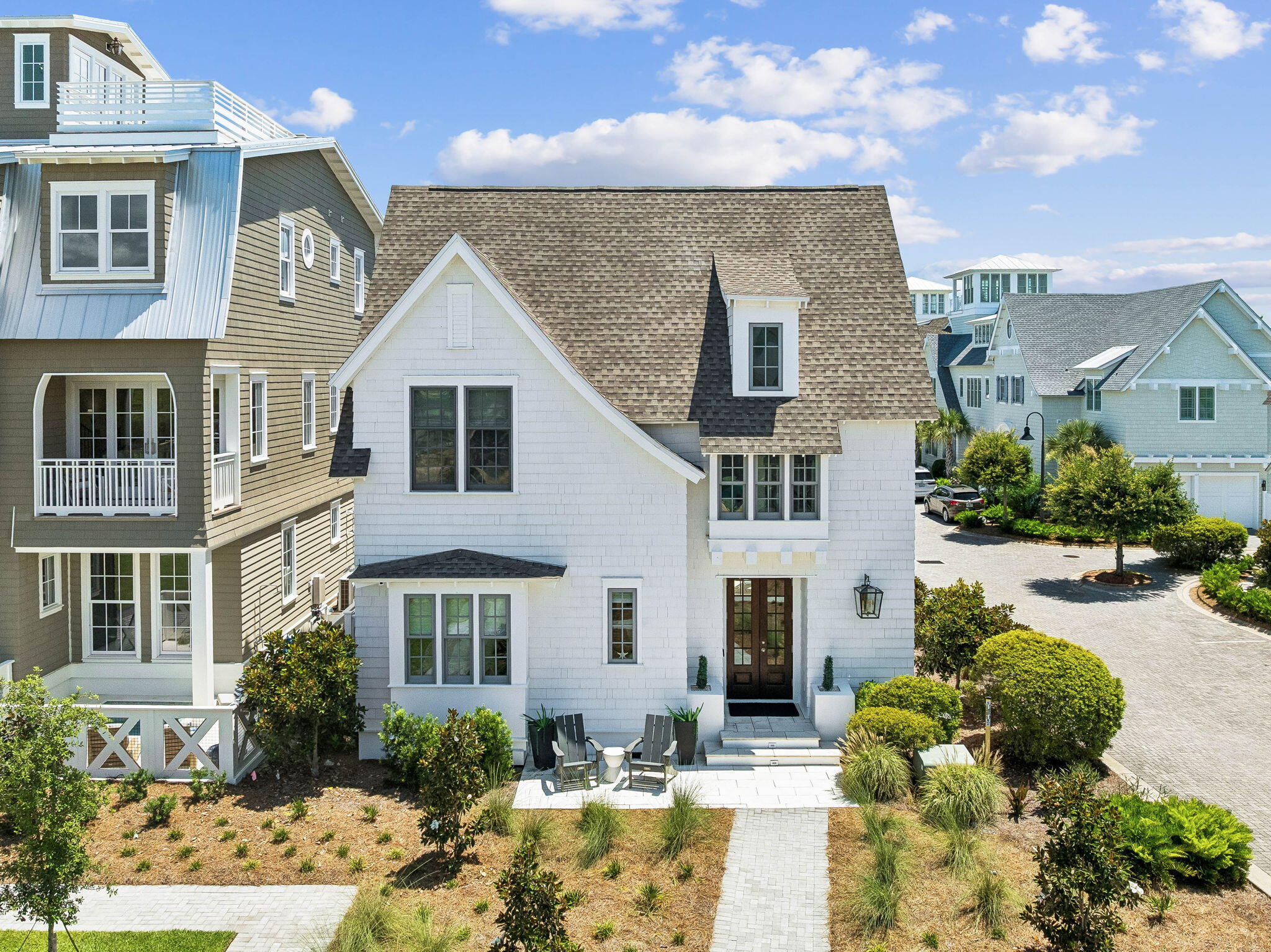 *Offered with a credit to cover the Watersound Club initiation fee with an acceptable offer*
Rarely does a home become available that offers this level of exclusivity, luxury, and location along Scenic Highway 30A. Located within the private gated community of Grace Point and just steps from the permanent, deeded members-only private gate access to the Watersound Beach Club, this designer-furnished 4-bedroom, 4.5-bath residence with a 2-car garage presents the opportunity to own the only home of its floor plan and design within the community. Offering 3,456 square feet of thoughtfully custom designed indoor and outdoor living and entertaining space, including 2,582 square feet of heated and cooled living area, the home showcases exceptional architectural detail with custom millwork, shiplap walls, hardwood flooring, premium Wolf appliances, curated furnishings, designer lighting, Wi-Fi thermostats, remote-controlled blinds, and an outdoor entertaining area featuring a hot tub, fire pit, new Wolf outdoor grill, and an existing permit to add a private pool. Sold fully furnished and meticulously cared for with minimal owner usage, this exceptional residence nestled just south of 30A represents a truly one-of-a-kind offering in Grace Point.  The open-concept living, dining, and kitchen spaces serve as the heart of the home, creating an inviting atmosphere for everyday living and effortless entertaining. The well-appointed kitchen features premium Wolf appliances, an oversized island, quartz countertops, shaker-style cabinetry, a classic subway tile backsplash, and generous storage, while the adjoining living area opens to the outdoor patio, where evenings are spent gathered around the fire pit, unwinding in the hot tub, or enjoying dinner from the new Wolf outdoor grill. A private first-floor guest suite with an ensuite bath offers added flexibility, while the second level is home to a beautifully appointed primary retreat complete with a morning coffee bar, spa-inspired bath, and spacious walk-in closet, along with two additional ensuite bedrooms, one featuring its own private balcony. Dual laundry rooms on both levels further enhance the home's everyday comfort and convenience. 

Grace Point is one of 30A's most sought-after gated communities, offering a private coastal setting with beautifully designed homes, peaceful surroundings, and an unmatched location directly along Scenic Highway 30A. Just steps from the Watersound Beach Club and minutes from Camp Creek, state park trails, Rosemary Beach, Alys Beach, Seaside, acclaimed dining, boutique shopping, and the Emerald Coast's renowned sugar-white beaches, the community places the very best of 30A within easy reach. Whether you're searching for a full-time residence or a luxury coastal retreat, 87 Grace Point Way offers a rare opportunity to own an exceptional home in one of 30A's most desirable communities.