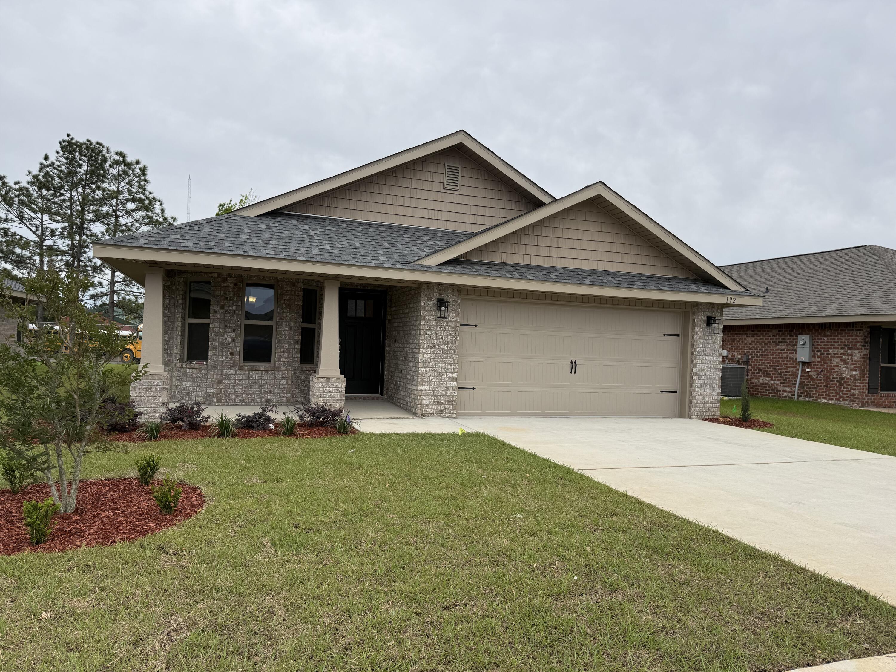 This home is sure to charm you! It offers 1717 sq ft of living space with 3 bedrooms and 2 bathrooms. It comes fully bricked, sodded, landscaped and with irrigation. It has craftsman style looks with a covered front and back porch! Inside you'll see a formal dining room that leads to the spacious kitchen overlooking the large family room. Laundry is conveniently located as you come in from the garage. The master bedroom has its own ensuite with double vanities and a 5' shower in lieu of tub. All cabinetry is solid wood and countertops are granite/quartz.This home comes with a 10 yr Bonded Builders warranty. The community has a beautiful pool for all to enjoy. The neighbor is well lit and has sidewalks. Shopping and dining are abundant.