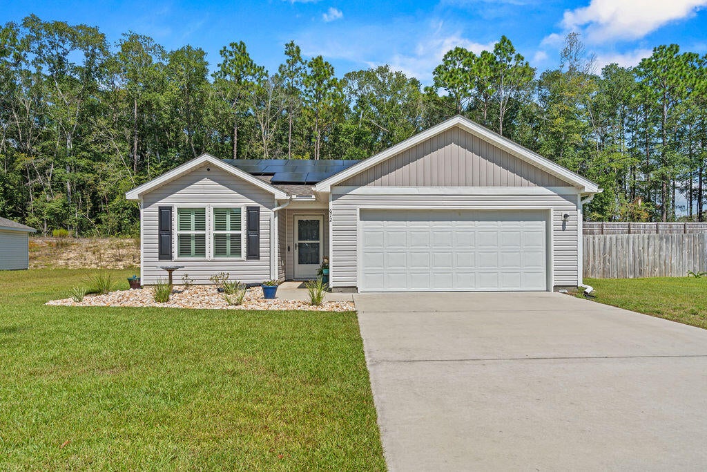 Welcome to 672 Squirrel Rd, a 3-bed, 2-bath pool home built in 2024 on a tranquil street bordering spring-fed Juniper Lake. Just a 4-minute walk to Juniper Lake Cat Island Park, this 1,343 sq. ft. home pairs low-maintenance living with a resort-style backyard, including a 320 sq. ft. covered lanai for a combined 1,663 sq. ft. of functional living space.

Inside, the kitchen was reconfigured this year with added cabinetry, a new peninsula, upgraded stone countertops, and a brand-new stove. Plantation shutters and smart home features complete the interior. The oversized double garage has textured, painted walls and ceiling, an epoxy floor, an EV charger, and extra storage space.

Out back, the 25' x 38' screened enclosure and paver deck offer 1,000+ sq. ft. of outdoor living, including 300+ sq. ft. of covered lanai. The 12' x 22' gunite saltwater pool (2025) features LED lighting, a variable-speed pump, a gas heater, and a 7' spa with waterfall. Gas lines are in place for a grill and firepit. Raised garden beds, young fruit trees, and a 10' x 16' shed round out the yard.

A fully paid-for 10kW solar system helps keep energy costs down, and all windows have hurricane protection. Off Hwy 83 with easy access to Hwy 331, you're about 35 minutes from Santa Rosa Beach and 30A, without the beach-zone congestion. Schedule your showing today!