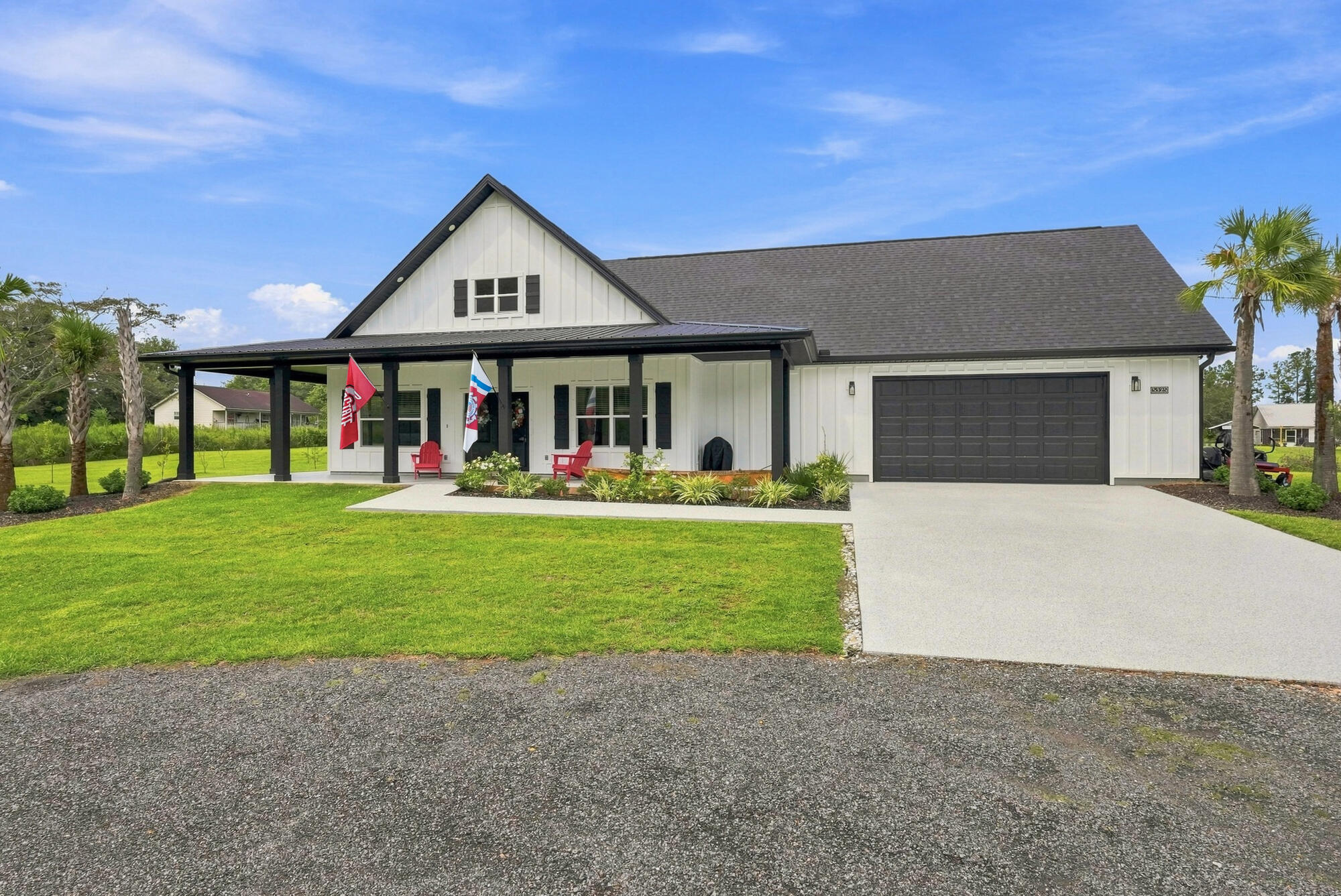 Better than NEW!! Enjoy privacy and country living with convenient proximity to downtown Jay! This 3BR/2BA farmhouse-style home sits on 1.63 acres with no HOA-bring your livestock, boat, RV and toys! Featuring 3,254 SQFT under roof, the home combines rustic charm with modern comfort, including white James Hardie board-and-batten siding, upgraded windows, shutters, gutters, black soffit/fascia and a 658 SQFT wraparound covered porch. Inside, the open floor plan showcases a vaulted wood ceiling, electric fireplace and abundant natural light. The kitchen offers generous counter space, an island with seating, stainless steel appliances and a walk-in pantry with custom shelving/cabinetry. The spacious primary suite features a tiled shower and large walk-in closet. Marble countertops, LED-lit mirrors, wood cabinetry, wood window sills, antique glass door knobs and LVP flooring add character throughout. Recent improvements include a whole-house Generac generator with two 250-gallon propane tanks, screened back porch, six-person hot tub, fenced backyard with two gates, epoxy-coated garage/front porch/back patio, six palm trees, new dishwasher, EV charger and hot tub surge protector. Septic was pumped and risers installed for exterior access, and the home's water line was also replaced. A 960 SQFT two-car garage includes an upgraded 8' door, indoor mechanical room, laundry sink and 12x30 attic space with potential for additional conditioned living area. Zero turn 54' Troy Built Mower  conveys. View your New Home Today!