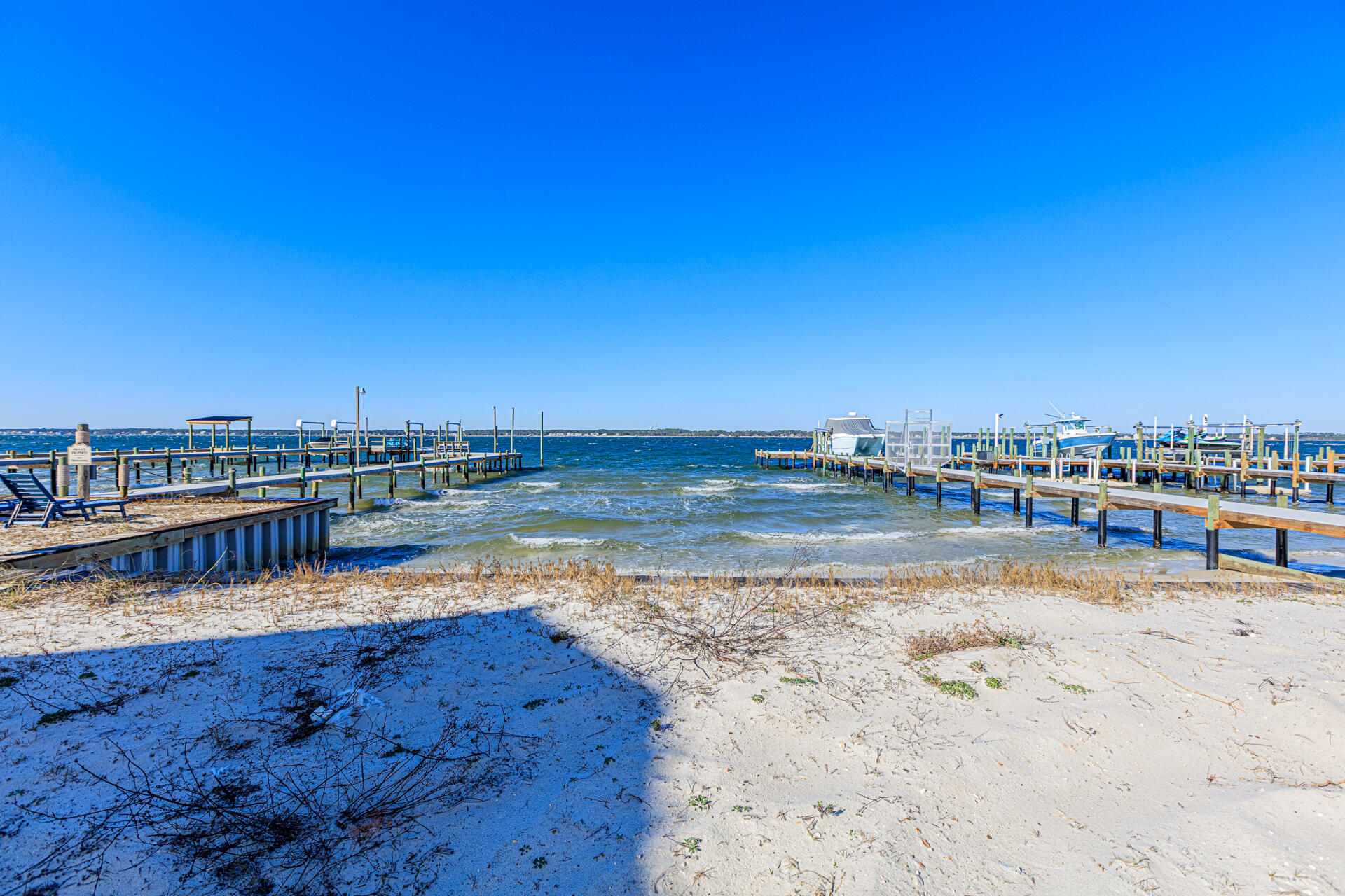 Rare west-end Navarre Beach waterfront homesite offering approximately 46 feet of direct Santa Rosa Sound frontage. This cleared, buildable lot provides an opportunity to design a custom coastal residence in one of the most desirable and limited waterfront locations on Navarre Beach, with Gulf Beach access only a short distance away. A survey is available so you know the dimensions, buildable area, and setbacks. Enjoy panoramic Sound views, boating and water access, and convenient proximity to the Gulf, restaurants, and Navarre Beach amenities. Short-term rental flexibility, and no HOA fees.  Navarre Beach is more than just a picturesque setting. It offers easy public access to the Gulf of America just 0.2 miles away, allowing for spontaneous beach days filled with sunbathing, swimming, and beachcombing along the sparkling shoreline. For those who love to fish or simply enjoy a day by the water, the iconic Navarre fishing pier is only 3.3 miles from your future doorstep. This local gem has a vibrant history and is surrounded by charming restaurants that serve fresh, delicious seafood, perfect for unwinding after a day of exploration. Make an offer today!
