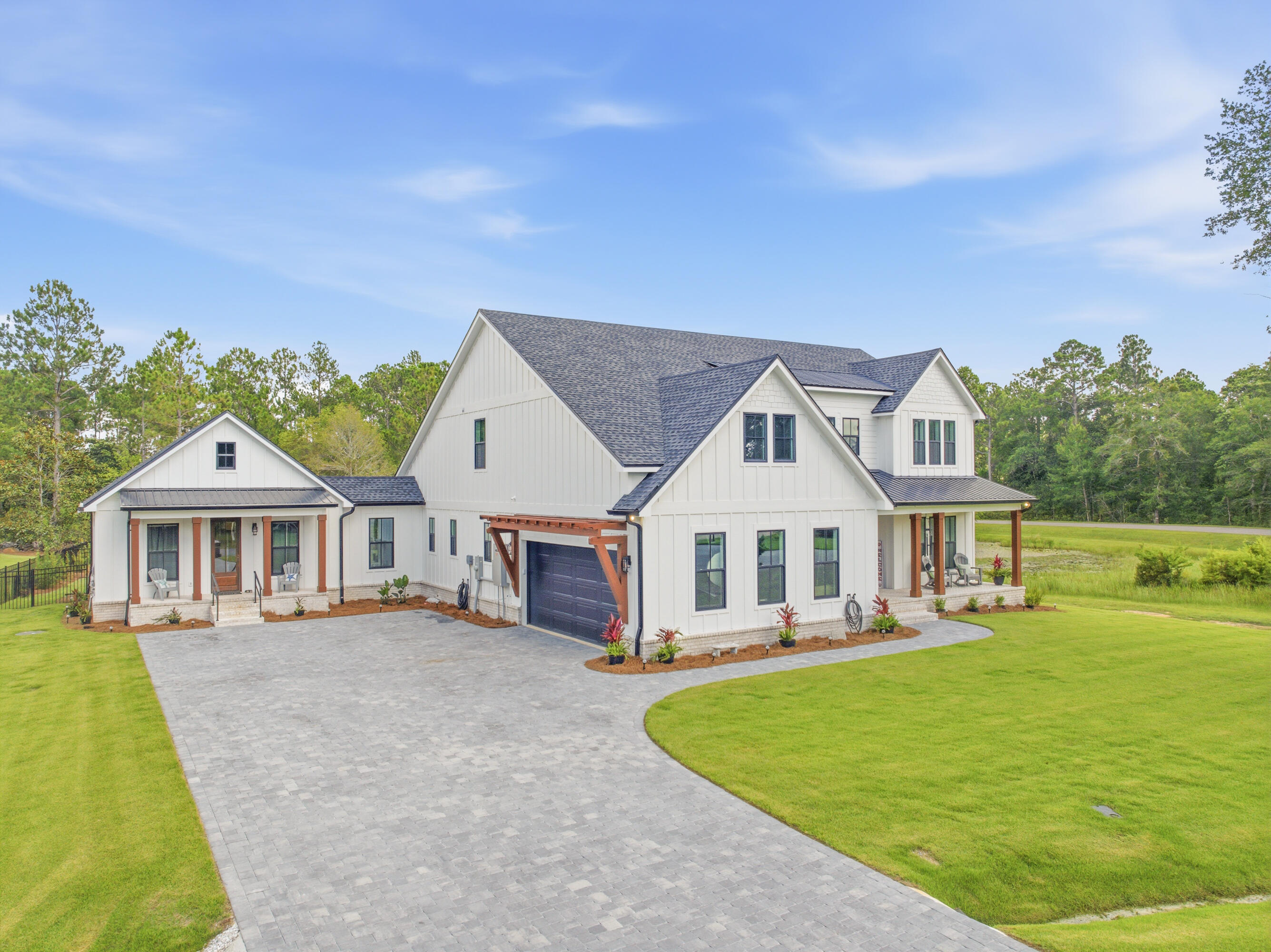 MAJOR PRICE IMPROVEMENT! Recently reduced and priced significantly below appraised value, this custom-built 2025 Bay Harbour home offers a rare opportunity to own a luxury residence with a separate guest house in one of Freeport's most desirable communities. Enjoy private access to Choctawhatchee Bay via a community dock and boardwalk, fishing pavilion, boat launch, RV and boat storage, beach area, and nature preserve. The main residence features 4 bedrooms, 4 full baths, a dedicated office, and a spacious loft/game room with wet bar. The chef's kitchen showcases a dramatic waterfall quartz island, premium built-in refrigerator, professional gas range with pot filler, custom cabinetry, and matching quartz countertops throughout. The luxurious primary suite offers a freestanding soaking tub, oversized walk-in shower, and custom closet. The separate guest house includes its own private entrance, full kitchen, living area, bedroom, bath, and laundry, making it ideal for guests, extended family, multigenerational living, caregivers, or a private workspace. Covered porches and high-end finishes throughout complete this exceptional property. Opportunities to purchase a newly completed custom home with this level of flexibility, quality, and community amenities are extremely limited. Dedicated pet wash station/dog shower in laundry room. Stem wall foundation. Low-E impact-rated windows and exterior doors, including tilt-in windows. Energy-efficient construction with spray foam attic insulation. Brick paver driveway and sidewalks. Herringbone brick porches. Zoysia grass. Three HVAC systems and two tankless water heaters. Walk-in pantry with custom shelving and secondary full-size refrigerator. Deep-well irrigation system. Custom floating shelving, custom closet systems, and numerous builder upgrades throughout.