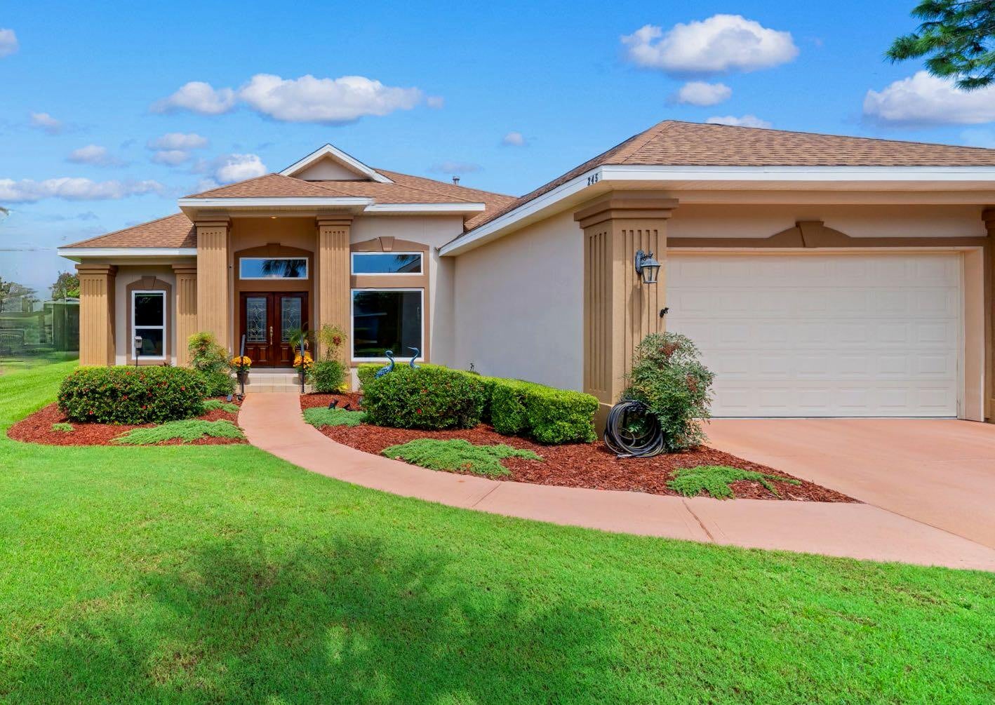 Welcome to 245 Okeechobee Cove, a Chris Roesller custom-built home located in the gated community of Emerald Lakes in Destin. Offering 4 bedrooms, 2.5 baths and 2,062 square feet, this well-appointed home features soaring 10 & 14-foot vaulted ceilings that create an impressive sense of space in the main living area. Hardwood flooring, tile and carpet are found throughout the home, with hardwood in the living room and primary bedroom.

The home has benefited from numerous updates over the years, including a remodeled kitchen and primary bath, hurricane-impact garage door, newer gas water heater in 2021, and a 15 SEER HVAC in 2023.

Step outdoors to a large screened-in patio offering plenty of space for relaxing, dining and entertaining. Beyond the patio, the backyard features a large pergola, brick pavers and a large garden area, creating a unique outdoor space to enjoy year-round with enough room to build a pool. 

Emerald Lakes is a gated Destin community with an impressive collection of amenities, including multiple lakes with walking paths,  a large community pool, pickleball and tennis courts, basketball court and a playground. Conveniently located near Destin's beaches, shopping, dining and recreation, this home combines custom construction, generous indoor and outdoor living spaces, extensive updates and sought-after community amenities in one inviting property.