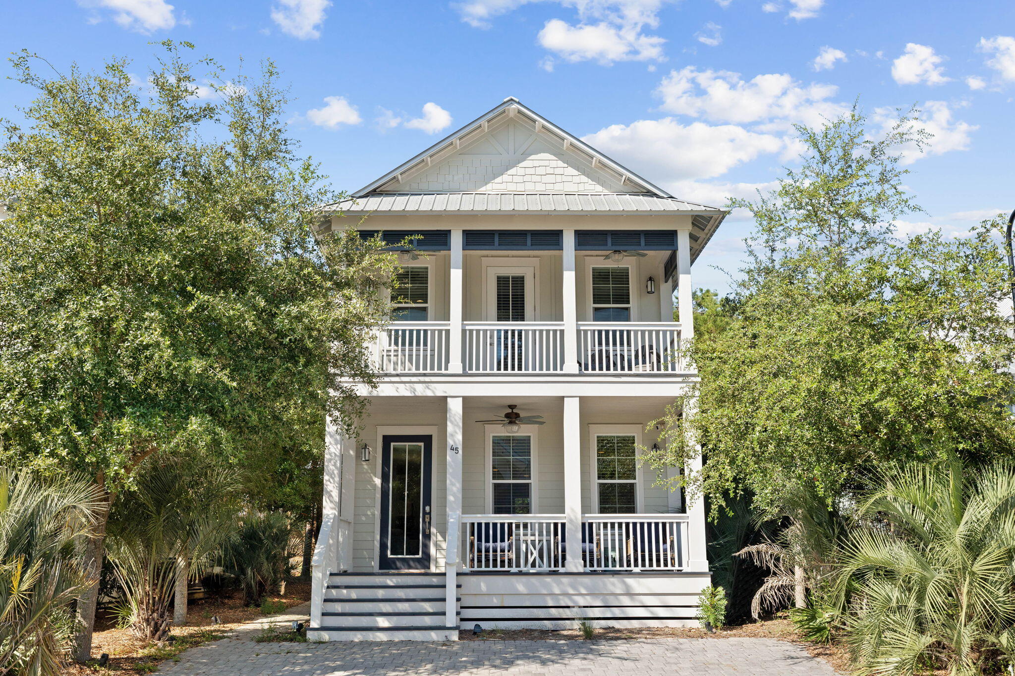 Coastal living meets everyday convenience in this ideally located four-bedroom, three-bath cottage, tucked along the quieter west end of Scenic Highway 30A and just moments from the vibrant Gulf Place Town Center. Here, the sugar-white sands and emerald waters of the Gulf are just a short stroll or golf cart ride away, with one of the area's largest public beach accesses providing plenty of room to settle in for a day in the sun. Enjoy the convenience of having local favorites like Shunk Gulley Oyster Bar, along with the boutique shopping, dining, and entertainment of Gulf Place, practically at your doorstep. With the community pool just three doors down, this home offers an ideal balance of coastal convenience and a relaxed neighborhood setting.
Inside, a spacious, open-concept main living level brings the kitchen, dining, and living areas together, creating an inviting space designed for gathering, entertaining, and making the most of time spent at the beach. Whether hosting a crowd for dinner or enjoying a quiet evening after a day on the water, the generous layout offers plenty of room to spread out and settle in. A guest bedroom and full bathroom on the main floor provide added flexibility, while multiple storage closets offer practical space for everyday living. Upstairs, three additional bedrooms include a guest room configured as a bunkroom and a second guest bedroom connected by a Jack and Jill bathroom. The primary suite offers a private retreat with direct balcony access, a generous walk-in closet, and the added convenience of a laundry area just off the suite, making everyday routines or extended stays effortless.
Outdoor living is equally inviting, with a welcoming front porch and an upstairs balcony offering two ideal spots to enjoy a leisurely morning coffee or unwind with a glass of wine as the sun sets. A quiet, shaded outdoor space provides a peaceful escape from the afternoon sun, perfect for relaxing after a full day of beach adventures. Additional exterior storage offers room for beach chairs, umbrellas, bicycles, fishing equipment, and all the gear that comes with embracing the active coastal lifestyle.
Whether you're seeking a vacation getaway, a full-time coastal residence, or a rental investment, this home offers a compelling combination of space, versatility, and an exceptional location. Spend your mornings on the beach, afternoons by the pool, and evenings enjoying fresh Gulf seafood, live music, and the laid-back atmosphere of Gulf Place, all without having to venture far from home. With easy access to the area's favorite coastal destinations and the quieter pace of west 30A, this is an opportunity to enjoy the coastal lifestyle exactly as it was meant to be lived.