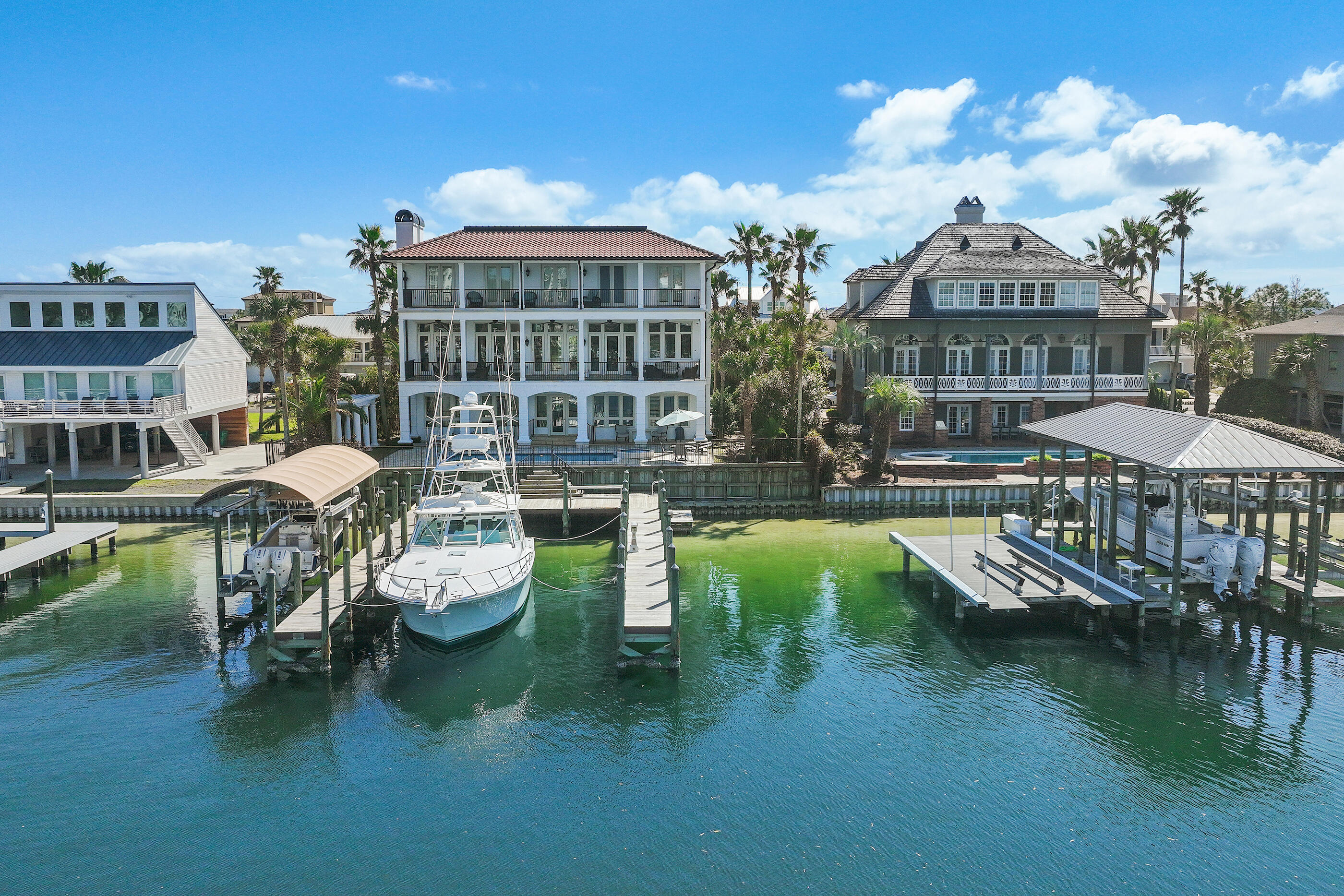 Welcome to 609 Lagoon Drive, a yachtsman's dream, this harbor-front luxury legacy home offers an exceptional opportunity to own on prestigious Holiday Isle.Positioned on deep water with a private boat slip accommodating a 70+ foot yacht, this property encompasses 90 feet of waterfront footage ideal for those who embrace the boating and fishing lifestyle. For the beach enthusiast you are a quick 5 minute walk or short golf cart ride to the beautiful, pristine, white sand beaches.  Spanning 5,192 square feet, this estate has been cherished as a family vacation home for almost two decades, designed for gathering, entertaining, and creating lasting memories. 
This home boasts beautiful hand selected white pine floors throughout, exposed hand hewn beams,  chefs kitchen with commercial grade appliances, custom cabinetry and stunning harbor views from every floor. The master suite situated on the third floor offers his and hers walk in cedar closets, separate vanities, garden tub and a walk in shower.
The french doors off of the master suite open directly to the luxurious covered balcony with panoramic views of the Destin Harbor to enjoy the beautiful sunsets over the water. 
A private study with fireplace directly off of the master suite and an elevator are just a few of the many amazing details that encompass 609 Lagoon Drive.
Enjoy the convenience of the Destin Water Taxi right off your dock for evenings out, and waterside dining. 

Contact Catherine Williams to find out more details or for a private showing.

Buyer to verify all dimensions