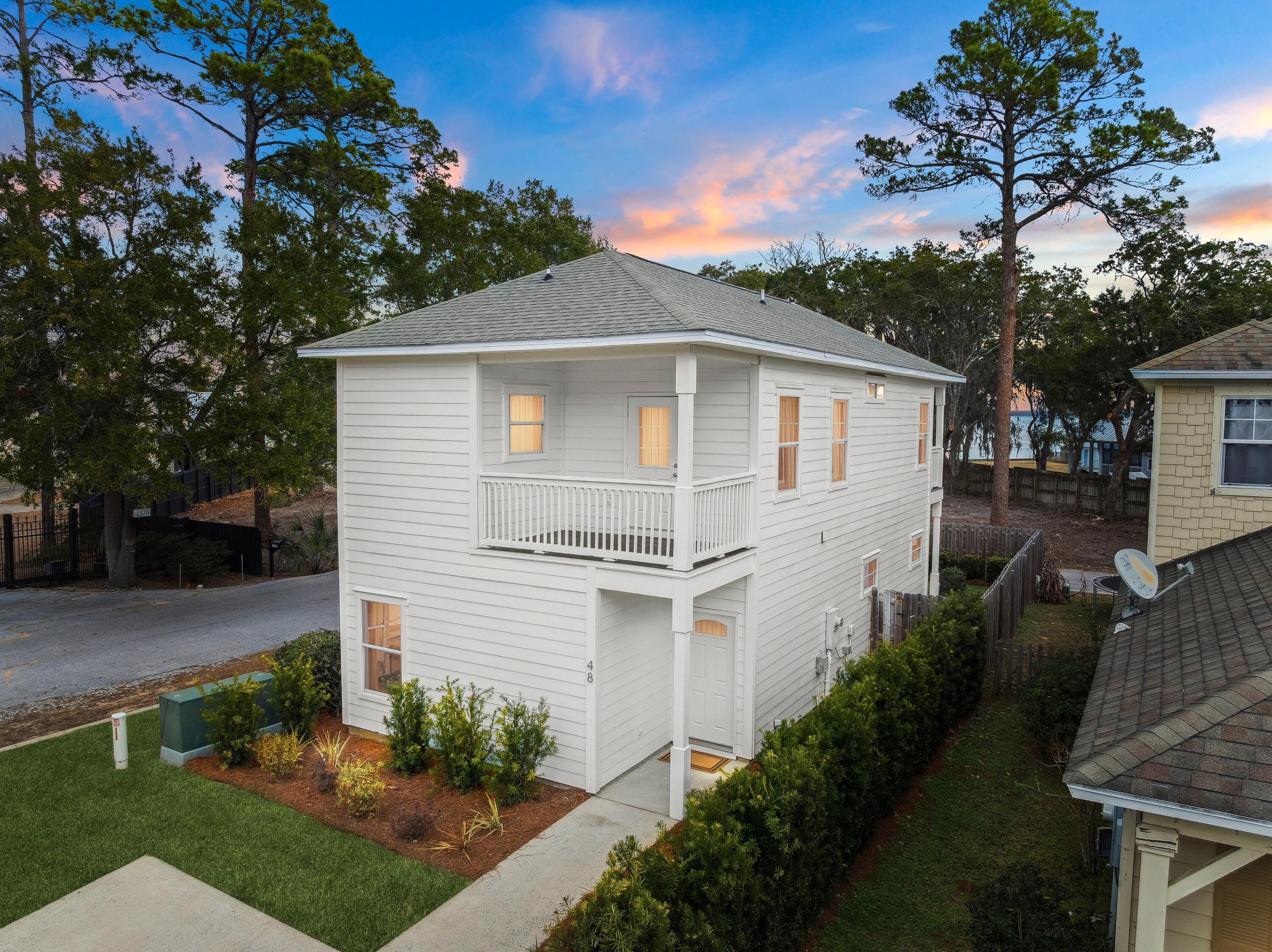 There is something quietly compelling about a home that understands its setting. Positioned directly across from the bay with stunning water views from both the first and second floors, this fully remodeled with a Brand New AC, Pine Trace bay retreat captures the calm rhythm of coastal living while remaining moments from the energy of 30A.

The approach is framed by lush new landscaping and a refreshed exterior that hints at the thoughtful renovation within. Inside, wide-plank LVP flooring runs throughout, setting a clean and cohesive tone. Just off the entry, a first-floor bedroom offers flexibility as a private guest suite or refined home office, paired with a full bath accessible from the hall. It is a layout designed with intention, offering convenience without compromising flow The main living space unfolds seamlessly, where kitchen, dining and living areas connect in one expansive open concept. New cabinetry, quartz countertops and all-new appliances anchor the kitchen with understated sophistication. Custom-built closets add tailored storage, while high-end tile finishes in each of the home's three full baths elevate the everyday experience. The living area extends naturally to a covered rear patio, an inviting space for evening conversations, morning coffee or simply watching the sunset.

Upstairs, two bedrooms -- the owner's suite and a guest suite -- each have their own full bath and open onto a balcony that stretches the length of the home. From here, bay views feel even more expansive. At the end of the hall, the primary suite offers a generous retreat with a walk-in shower, double vanity and a spacious walk-in closet designed for ease and organization.

The location is equally compelling. Just seven minutes from the Gulf Place beach access off 393, with new parking, shopping and dining nearby, this address offers remarkable accessibility. Cessna Landing boat launch, bayfront parks and local restaurants are close at hand. The planned 10,000-seat amphitheater, set on 220 acres with walking trails and six lakes, signals exciting growth and enduring value for the surrounding area.

Set on a quiet street with minimal traffic and no short-term rental restrictions, this property presents exceptional versatility as a primary residence, second home or investment opportunity. Water views. Refined finishes. A thoughtful renovation from top to bottom. Coastal living, elevated and effortless.