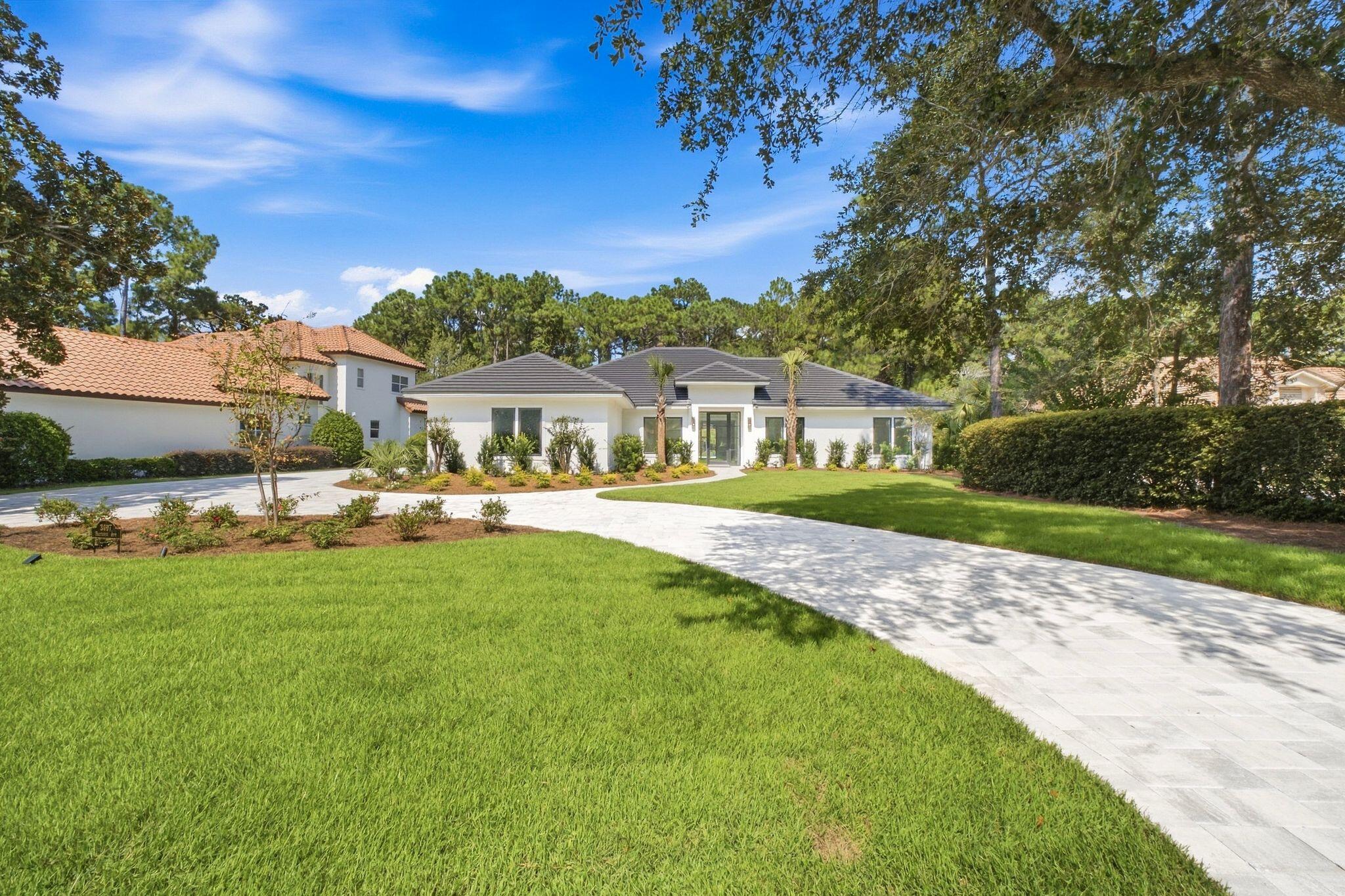 Completely rebuilt from the slab up, this exceptional Coastal Modern residence offers the rare combination of refined design, privacy, and resort living in the heart of Sandestin Resort. Situated on nearly half an acre along Baytowne Avenue, the property backs directly to a state-owned natural reserve, providing a peaceful and private backdrop with no future residential development behind the home.

Designed entirely on one level, the home features five bedrooms, four and a half baths, a dedicated office, an oversized mudroom, and an expansive open-concept kitchen and living area. The thoughtfully designed floor plan creates an effortless connection between the interior and outdoor living spaces, with large sliding glass doors in both the living room and primary suite opening to the private backyard.

The kitchen is a true centerpiece, featuring Viking gas range and refrigerator, a custom François hood, and a cleverly concealed butler's pantry hidden behind cabinetry that seamlessly matches the kitchen. Just off the kitchen is a dedicated bar area complete with a wine refrigerator and ice maker, making the space ideal for entertaining. The spacious primary suite offers a luxurious retreat with a large walk-in shower, freestanding soaking tub, and oversized walk-in closet featuring custom lighting. One additional bedroom was thoughtfully designed with a home gym in mind and includes an infrared sauna.

The outdoor living area is equally impressive, featuring a large fully fenced backyard, resort-style pool and hot tub, covered grilling and entertaining area, and an outdoor shower. The expansive backyard and natural reserve beyond provide an exceptional sense of privacy rarely found within Sandestin.

The home has been comprehensively rebuilt with all-new windows, doors, plumbing, electrical, roof, and tankless gas water heater. Tile flooring runs throughout the entire residence, complementing the clean lines and Coastal Modern aesthetic.

Additional features include an oversized two-car garage that fits two cars & two golf carts, an expansive driveway with abundant parking, new landscaping and landscape lighting, and a welcoming front entry illuminated by elegant gas lanterns.

Located within Sandestin Resort and conveniently positioned along Baytowne Avenue, this remarkable property offers the opportunity to enjoy a beautifully reconstructed home, exceptional privacy, and all the amenities and lifestyle associated with one of the Emerald Coast's premier resort communities.