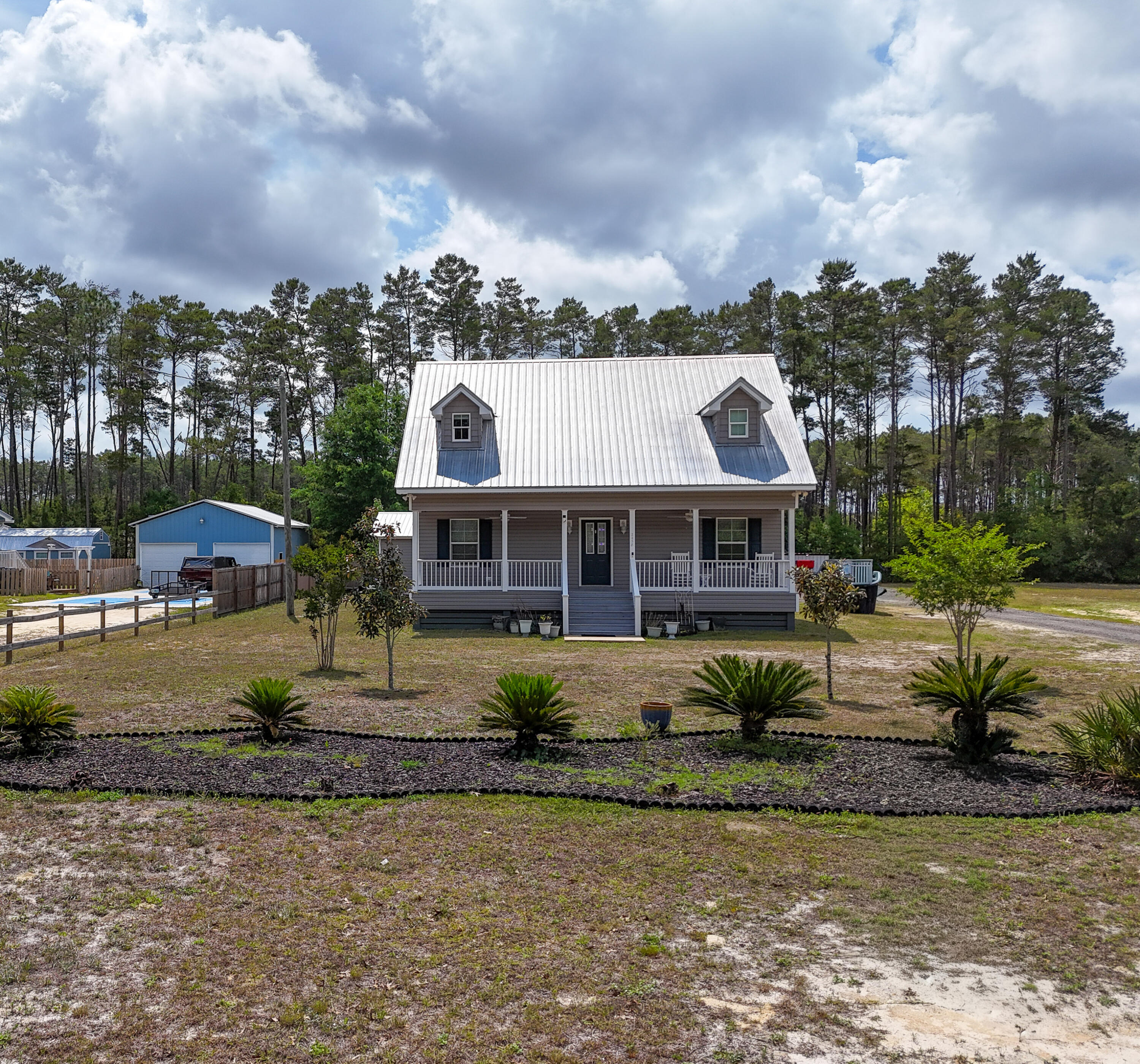 $10,000 seller credit toward buyer's closing costs. Welcome to your private coastal retreat! Home blends comfort, functionality, and outdoor living. The first floor features the primary suite, spacious living area, kitchen, laundry room, and half bath, all accented by beautiful pine flooring. Upstairs offers two large bedrooms and a full bath, providing plenty of space for family and guests.

Designed for entertaining, the property boasts expansive front and back porches, a cooking pavilion, bar area, and hot tub--perfect for relaxing after a day on the water. Fishing and boating enthusiasts will love the deeded private access to a boat launch and fishing dock on Black Creek with direct access to Choctawhatchee Bay.

A detached mother-in-law suite includes its own bedroom, kitchen, lounge area, full bath, and oak flooring, making it ideal for guests, rental income, or multigenerational living.

Additional features include covered parking for two vehicles, a walk-in cooler for your fresh catch, and fruit-bearing lemon, olive, peach, and fig trees. Conveniently located just 20 minutes from Grayton Beach and 25-35 minutes from Sandestin and Destin Commons shopping and dining. No HOA! Enjoy the ultimate coastal lifestyle with exceptional boating, fishing, and entertaining opportunities.