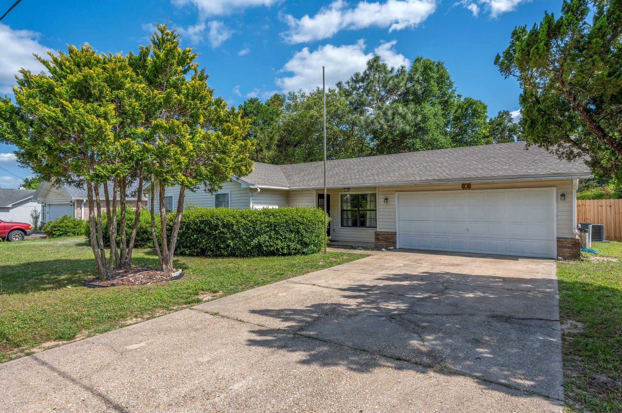 This spacious home features a roomy floor plan located on the south end of Crestview. Close to stores, grocery, and schools.  Step inside this 3 bedroom, 2 full bath home and fall in love with the all-tile flooring throughout and vaulted ceiling in the living room and master bedroom. The updated kitchen features stainless steel appliances, granite counters, and clean white cabinetry.  Bedrooms all boast tile floors for ease of cleaning. Two car garage is a bonus for storage and your vehicles. Once outside enjoy a large fenced backyard, covered porch, open porch, and large lot for privacy. Subdivision has underground utilities and sewer system connection (no septic).