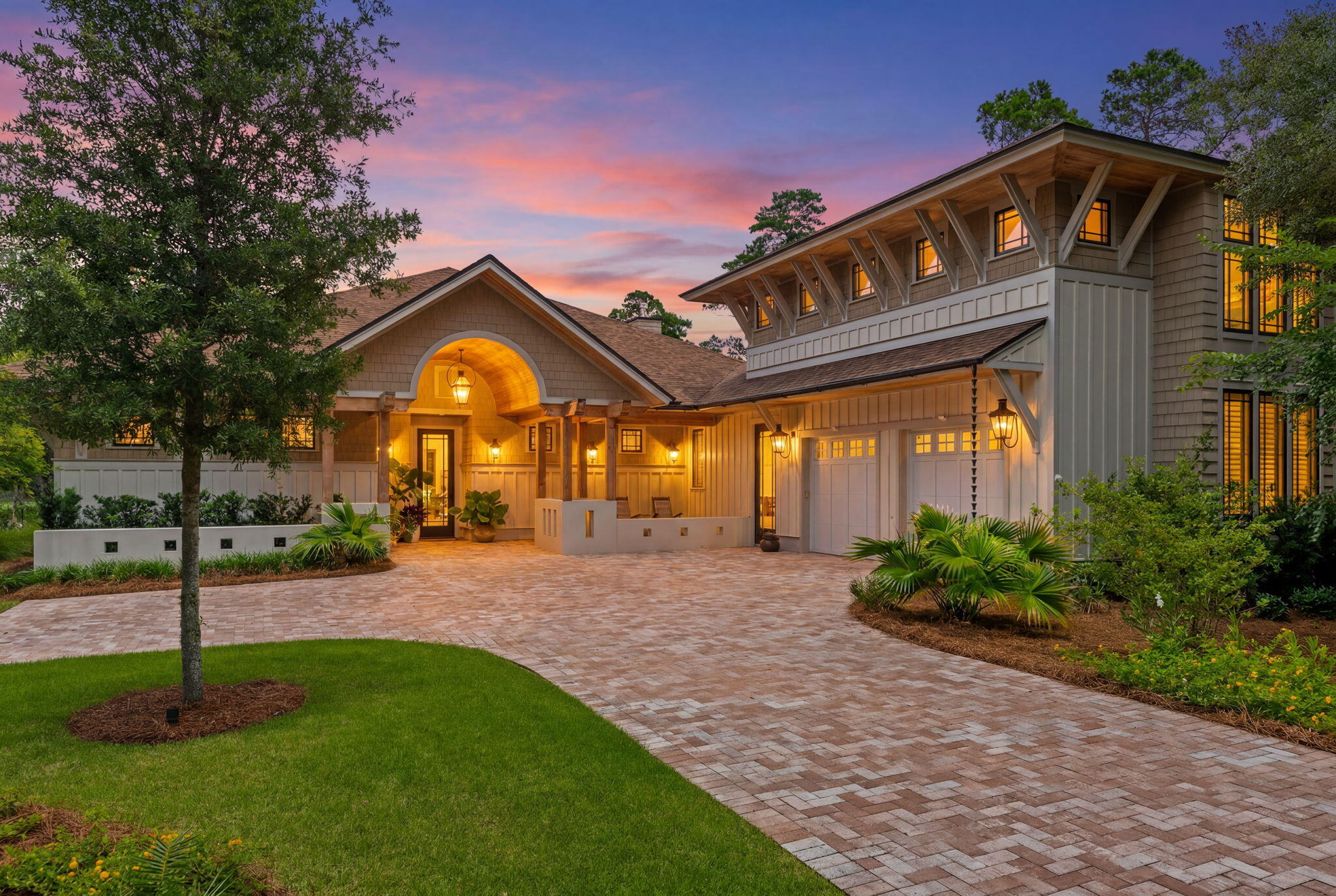 Nestled behind the guarded gates of the exclusive 734-acre Wild Heron preserve, this remarkable Coastal Craftsman estate, masterfully crafted by Regal Stephens, combines unparalleled privacy with world-class design. The exterior immediately commands attention with its striking cedar shake siding, beautifully laid paver driveway, deep exposed-wood brackets, and a dramatic arched entry pavilion. Inside, the home seamlessly blends casual coastal sophistication with meticulous custom millwork, showcasing warm wide-plank hardwood floors, a stunning whitewashed stone fireplace, and a striking tray ceiling wrapped in natural wood beams and blonde wood tongue-and-groove paneling. The chef's kitchen is an absolute showstopper, featuring sleek inset cabinetry, open floating shelving, leathered quartz countertops, an elegant mosaic tile backsplash, a professional gas range under a grand custom hood, a pot filler, and a hidden walk-in pantry behind a crisp white barn door. On the main level, comfort meets luxury with 3 spacious downstairs bedrooms, all comfortably accommodating king beds, two of which feature their own private ensuite bathrooms. This includes the elegant primary suite, complete with a crisp coastal color palette, built-in custom cabinetry, and its own private linear fireplace. Upstairs, a sprawling, versatile secondary living space or guest suite features a built-in kitchenette with a bar sink, beverage fridge, and microwave.  The indoor-outdoor flow is unmatched, leading to a massive, fully screened outdoor living compound backing up to a serene, wooded landscape. This backyard oasis features a resort-style pool and integrated spillover hot tub wrapped in premium travertine decking, luxury in-water lounge chairs, a built-in summer kitchen with a professional-grade DCS grill, and a magnificent tongue-and-groove paneled lanai with a soaring stone-accent wall and linear fireplace. Seamlessly blending into the natural landscape, the backyard layout offers a coveted peek-a-boo view of a tranquil pond, frequently visited by local herons, alongside beautiful views overlooking the 13th hole of the course. Living in Wild Heron means embracing a lifestyle centered on nature and luxury along the shores of Lake Powell, North America's largest coastal dune lake, with world-class amenities including a lakeside resort pool, a fitness center, a boathouse, & firepit. Watersound Club members can enjoy access to the renowned Greg Norman-designed Sharks Tooth Golf Course, clubhouse, & tennis.