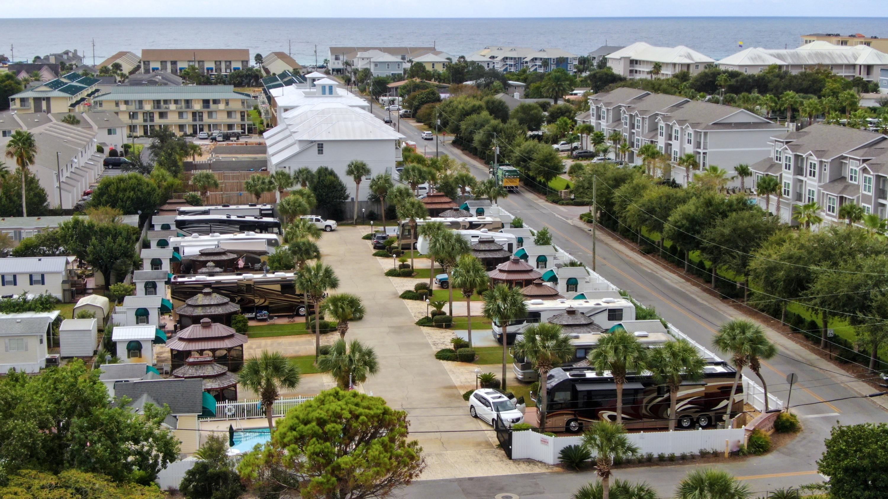 Enjoy the ultimate coastal RV lifestyle with this premium Motorhome Lot located in a small, exclusive Gated Community just two blocks from the renowned white-sand beaches of Miramar Beach. Ideally situated as the second lot from the Community Pool on the desirable East side of the resort, this property offers both convenience & privacy. The lot features a spacious Gazebo, an upgraded Coach House with luxury vinyl plank (LVP) flooring & attractive paneled walls, creating a comfortable & inviting retreat. Additional improvements include an expanded paver area & outdoor deck, providing exceptional space for relaxing, entertaining & enjoying the Florida sunshine. The property also conveys with additional storage units, offering valuable extra storage capacity. The low Annual HOA fee of just $2,500 includes water, sewer, lawn maintenance, trash service, irrigation system maintenance, liability insurance for common areas, pool maintenance & more - making ownership both convenient & affordable. A rare opportunity to own a beautifully improved lot in one of Miramar Beach's only Class A/Super C Motorhome Communities. Enjoy resort-style living just moments from the Gulf of Mexico, dining, shopping & entertainment. Convenient Location. Close to bike/walking paths & public Beach Access by Pompano Joe's Restaurant. ONLY 'Class A' Coaches allowed, No 5th Wheels or Trailers. Won't last long! Public Beaches with parking, public bathrooms and Pompano Joe's Beachside restaurant. Enjoy snorkeling at the Manmade Reef. Scenic Gulf Drive has Bike/Pedestrian Paths along the road offering beautiful Beach Views. Buyer Pays $500 Capital Contribution at Closing.