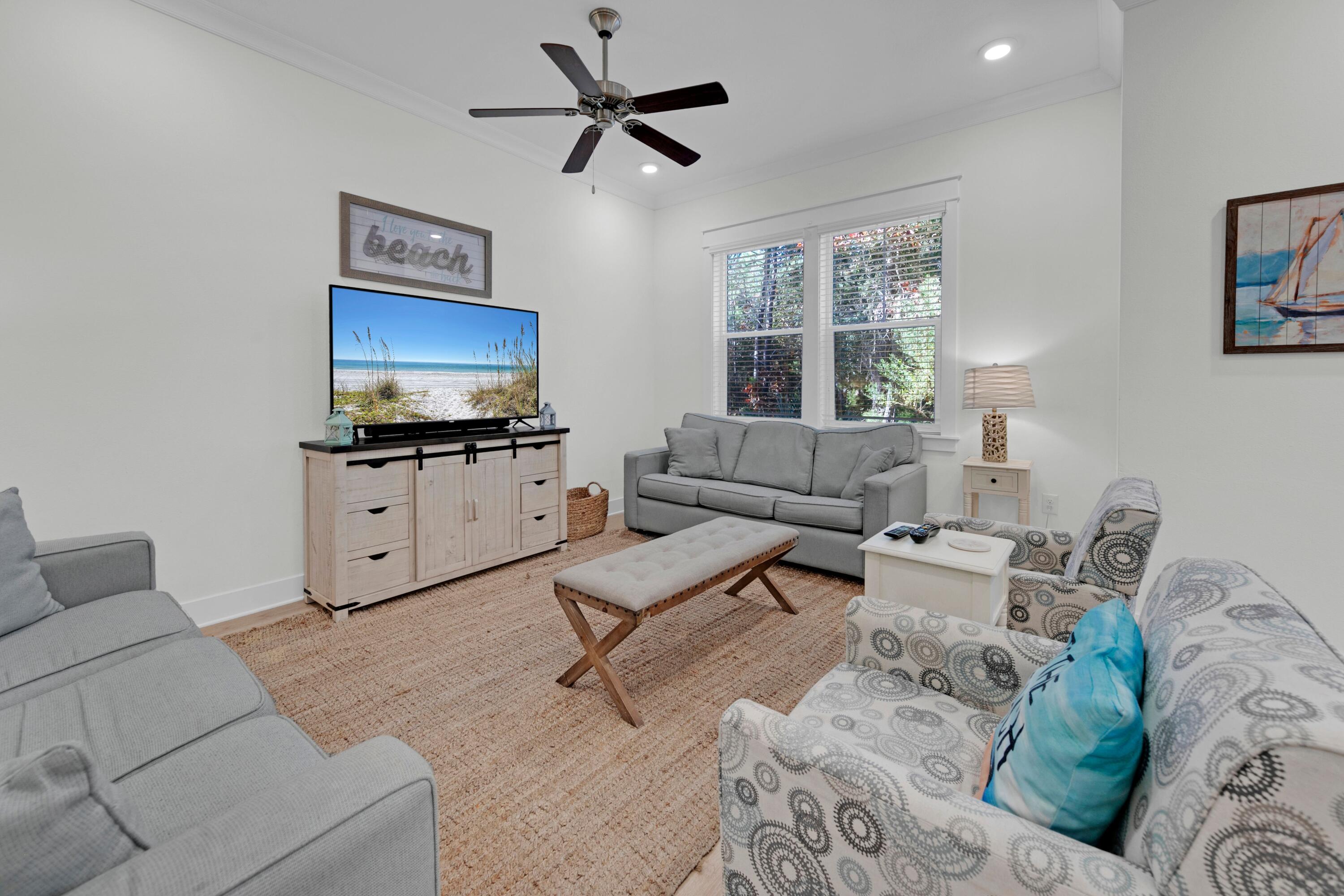 Luxury abounds in this beautifully updated end-unit townhome in Prominence, backing to the tranquil State Forest for added privacy. Two blocks from the Resort Pool. 3 spacious bedrooms, a two-car garage, and a paver driveway with ample parking, this home offers both elegance and practicality. The garage easily accommodates a golf cart, bikes, and beach gear, while the laundry room provides extra storage for towels and toys. Inside, light pine floors, fresh décor, and updated furnishings create a soft coastal ambiance. The gourmet kitchen boasts stainless appliances, quartz countertops, and a large island perfect for gathering and meal prep with peaceful forest views.
