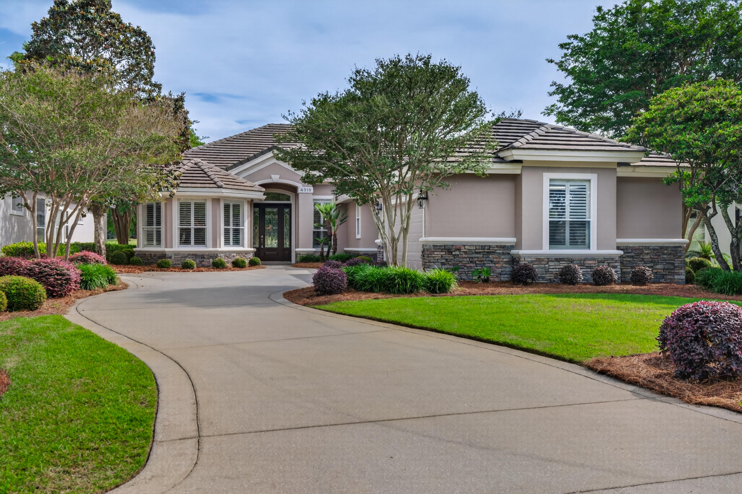 NEW PRICE!!!Nestled within the highly sought-after community of Kelly Plantation, this beautifully maintained home in Carriage Place offers breathtaking waterfront views of both the lake and the 14th hole on the golf course. Ideally located near the sugar-white sands and crystalline-green waters of the Emerald Coast, the property also provides convenient access to premier shopping, dining, and local amenities.

The home features a meticulously landscaped yard with mature greenery, creating a welcoming and serene curb appeal. For golf enthusiasts, the garage includes a dedicated enclosed space for a golf cart. Recent updates-including fresh paint, modern lighting, and structural enhancements-make this home perfect for both everyday living and entertaining.
The spacious kitchen is a standout, showcasing custom wood cabinetry, granite countertops, under counter lighting, and abundant storage. A long countertop provides the perfect space for buffets or displaying small appliances, while a separate nook is ideal for a coffee bar. The open-concept layout flows seamlessly into the family room, creating a warm and inviting gathering space. Sliding glass doors lead to a large screened-in lanai, extending your entertaining area outdoors. The lanai is accessible from both the main living areas and the primary suite.

The family room is designed to accommodate a large-screen TV, easily visible from the kitchen for effortless entertaining. There are speakers for great sound in the family room, the lanai, the living area and the master bedroom. The primary suite features a tray ceiling, private access to the lanai, and ample space for king-sized furnishings. Dual closets provide generous storage, while the ensuite bathroom includes under cabinet lighting, a walk-in shower, soaking tub, and a separate water closet for added privacy.

At the front of the home, a sunlit room with expansive windows and built-in bookcase offers a perfect setting for a home or reading retreat. The built-in features 4 large file drawers and ample storage for a home office. The additional bedrooms are generously sized, providing comfort and flexibility for family or guests.

Pride of ownership is evident throughout this meticulously cared-for property. Residents of Kelly Plantation enjoy a wide array of community amenities, enhancing both lifestyle and convenience.
Buyers to verify all lot and home dimensions. The listing is enhanced with AI furnishings, but the home is being sold unfurnished. The small accessories are property of the realtor but can be purchased outside closing. Buyers to verify all lot and home dimensions. The seller is offering a home warranty from Assurant