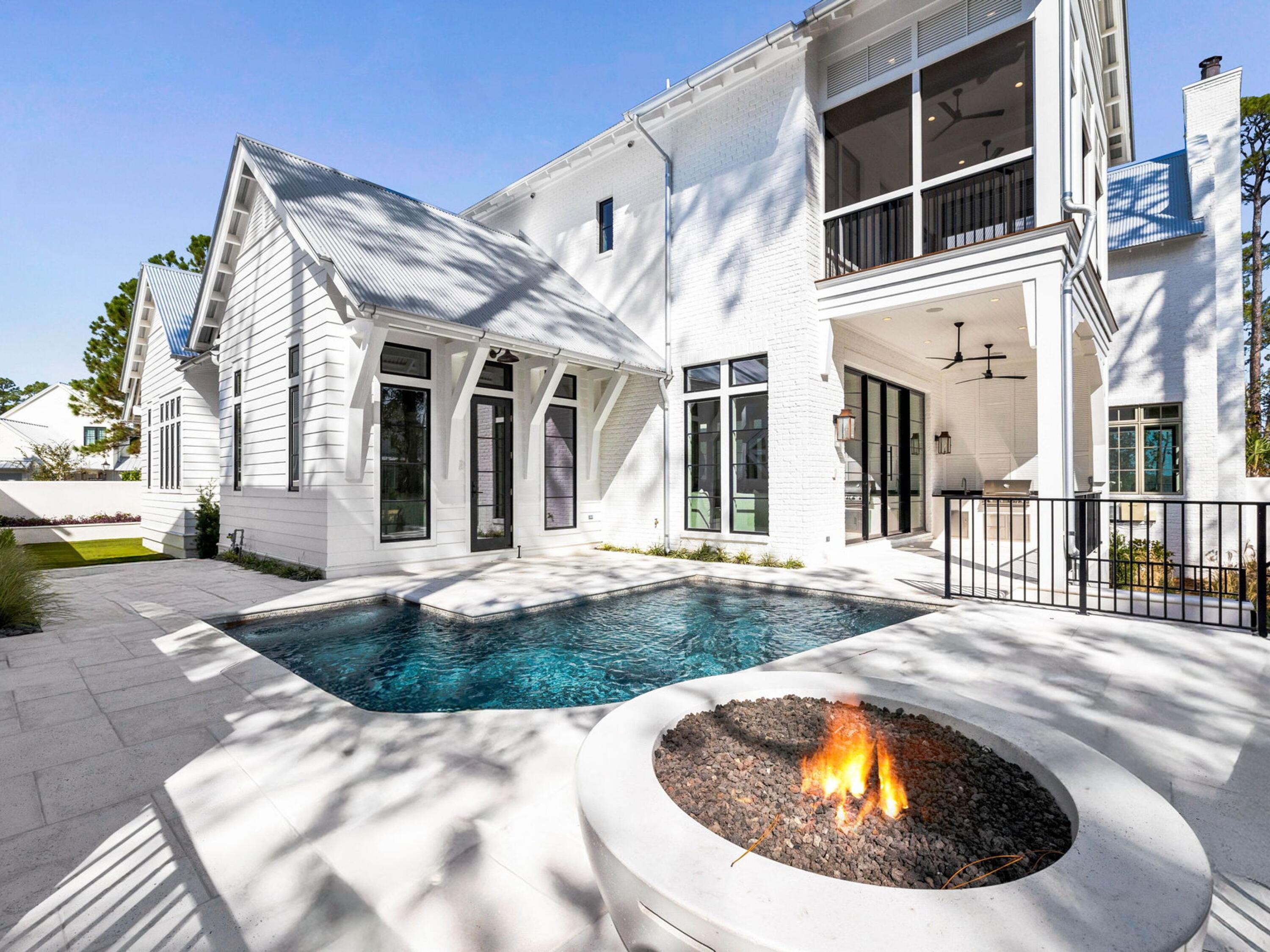 Located within the gated waterfront community of Churchill Oaks, this thoughtfully designed residence offers a refined take on coastal living with a focus on effortless indoor-outdoor flow and elevated everyday comfort. Positioned just north of 30A, the home pairs a private setting with access to a bayou front marina, clubhouse, and resort-style infinity pool.

Designed for both entertaining and daily living, the home features a private pool, two-car garage, and a flexible layout with two primary suites. The main living area is anchored by soaring 12-foot ceilings and expansive 10-foot Euro-wall sliders that open seamlessly to the outdoor living space, creating a natural extension of the home. Interior finishes blend warmth and sophistication with Venetian plaster walls, white oak flooring, and curated architectural details throughout. The kitchen is designed for both function and presentation, featuring a 48-inch Wolf dual-fuel range with griddle, 48-inch Sub-Zero refrigerator, 6cm honed marble island, butler's pantry, and a wet bar with beverage refrigeration.

The main-level primary suite offers vaulted ceilings, a spacious bath with dual vanities and soaking tub, and direct access to the L-shaped plunge pool. Upstairs, a secondary living area with wet bar provides additional space to gather, along with a second primary suite featuring a custom walk-in closet, screened balcony, and a wet-room-style bath with garden tub and shower.

Outdoor spaces are designed for low-maintenance enjoyment, complete with an AstroTurf lawn, fire pit, and summer kitchen with built-in grill, sink, and refrigerator.

Churchill Oaks residents enjoy gated privacy along with access to a private marina, bayou front clubhouse, and community pool, all within close proximity to the beaches, dining, and shopping of 30A.