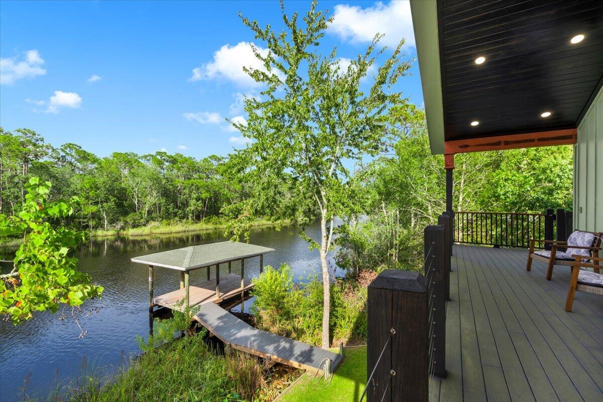 A rare opportunity to own a custom-built RIVERFRONT home on Navarre's East River. New construction set on an oversized waterfront lot with approximately 161 feet of frontage, this property offers direct access to the Bay and Gulf with a pier extending from the home to the water and a covered dock--ideal for boating, fishing, paddleboarding, and enjoying waterfront living.

Constructed to Florida Hurricane Code and FEMA standards, the home is elevated on pilings and features a metal roof, composite decking, and expansive wraparound porches designed to take full advantage of the unobstructed water views. 

Inside, the home offers an open-concept layout with cathedral ceilings, exposed beams, real hardwood flooring, and a warm, custom feel throughout. The kitchen features stone countertops, a butcher-block island, stainless steel appliances, and functional workspace, while the bath includes a spacious walk-in tiled shower with a spa-inspired feel. With 2 bedrooms, 1 bath, distinctive craftsmanship, substantial waterfront footage, and a covered dock already in place, this property offers a unique combination of waterfront access, quality construction, and future potential. Whether used as a primary residence, second home, or vacation getaway, 8536 Kingsley Place presents an uncommon opportunity on the East River.
